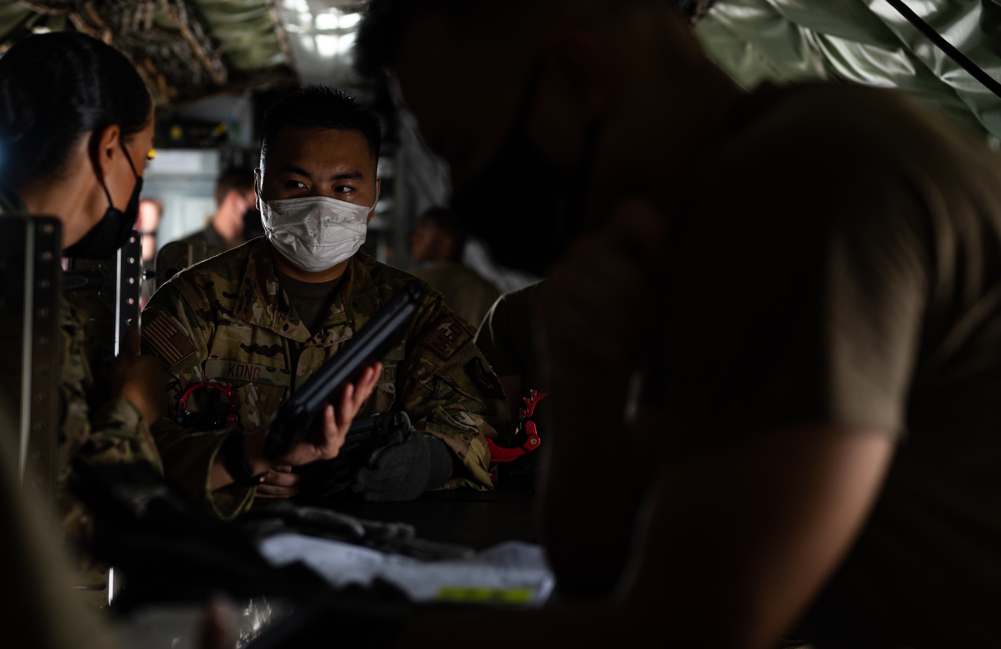 Airmen discuss medical procedures on a KC-135.