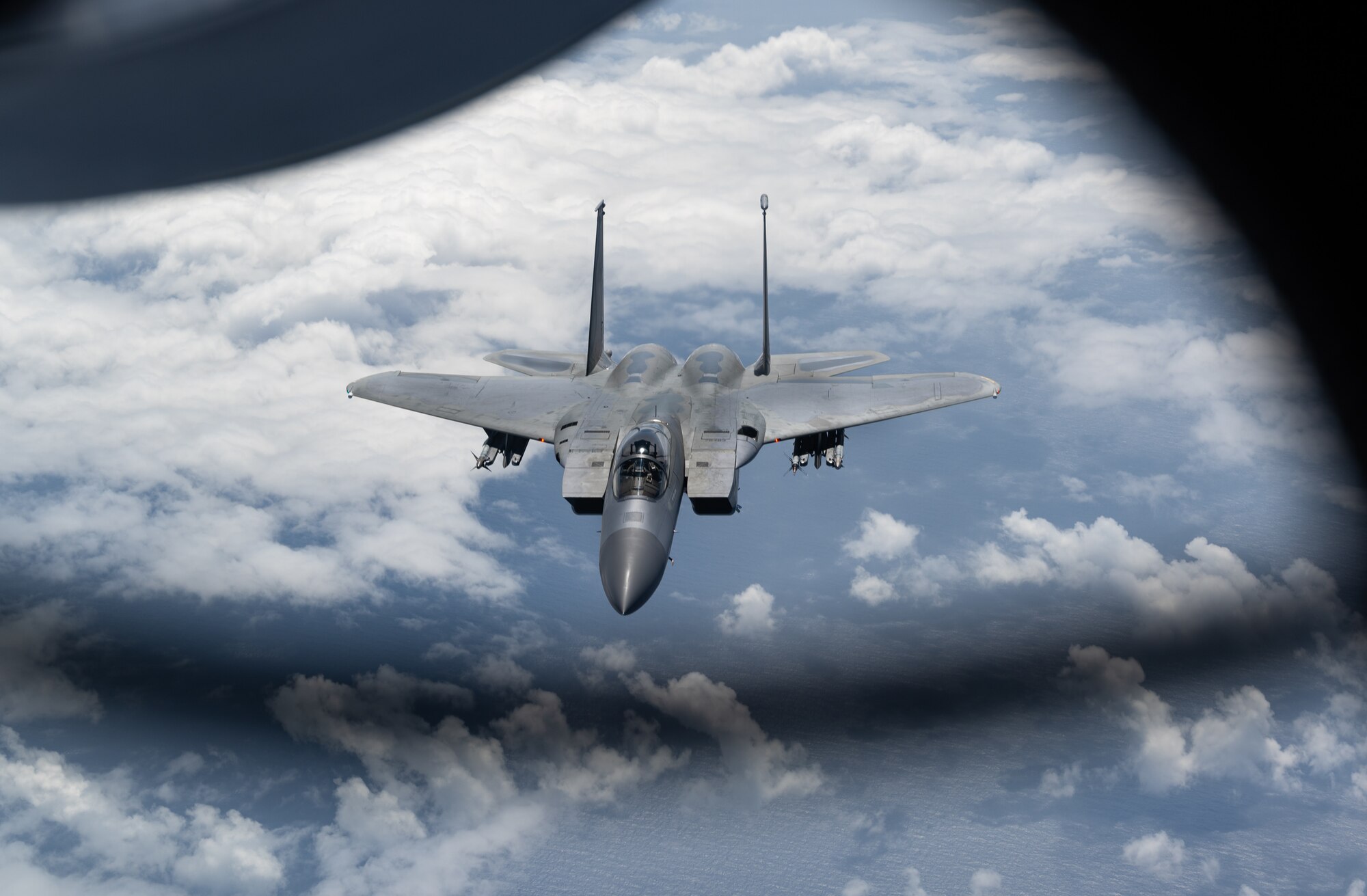An F-15C Eagle flies over the Pacific.