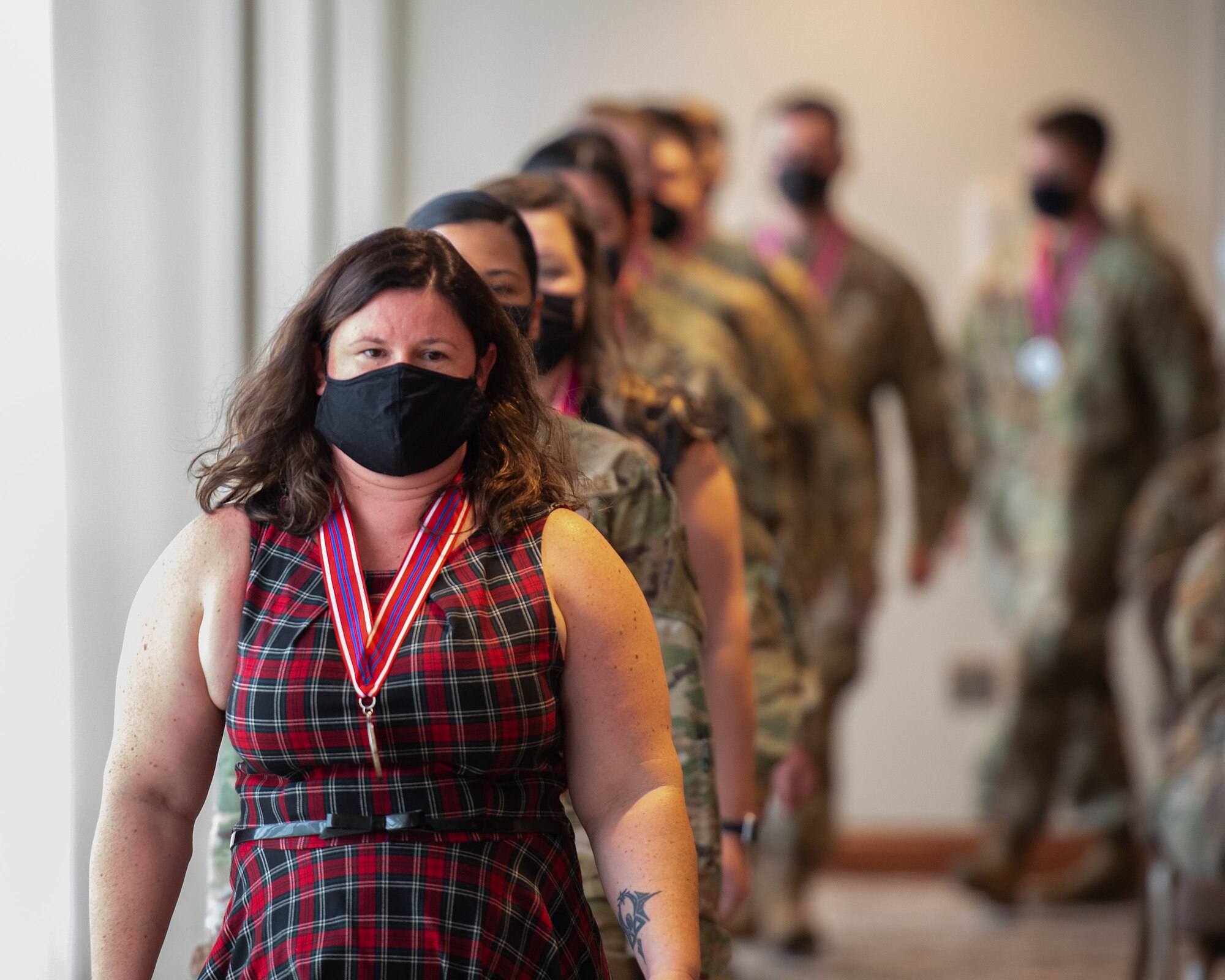 Kathaleen Berhiet, an Air Force Life Cycle Management Center administrative assistant, leads her Airman Leadership School classmates in for their graduation ceremony Oct. 14, 2021, at the Wright-Patterson Club. (U.S. Air Force photo by R.J. Oriez)