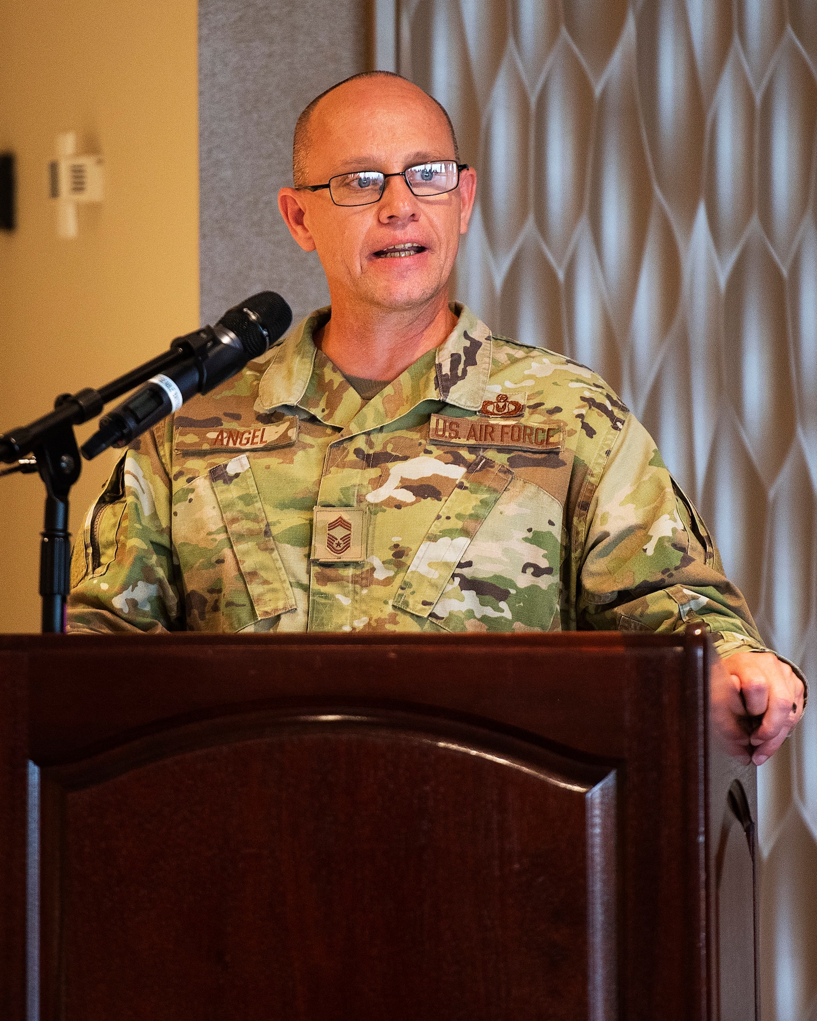 Chief Master Sgt. Theodore Angel of the Air Force Life Cycle Management Center’s Aircrew Performance Branch gives the keynote address to Airman Leadership School Class 21-G during its graduation ceremony Oct. 14, 2021, in the Wright-Patterson Club. Angel was class mentor for the 24 Airmen and two civilians. (U.S. Air Force photo by R.J. Oriez)