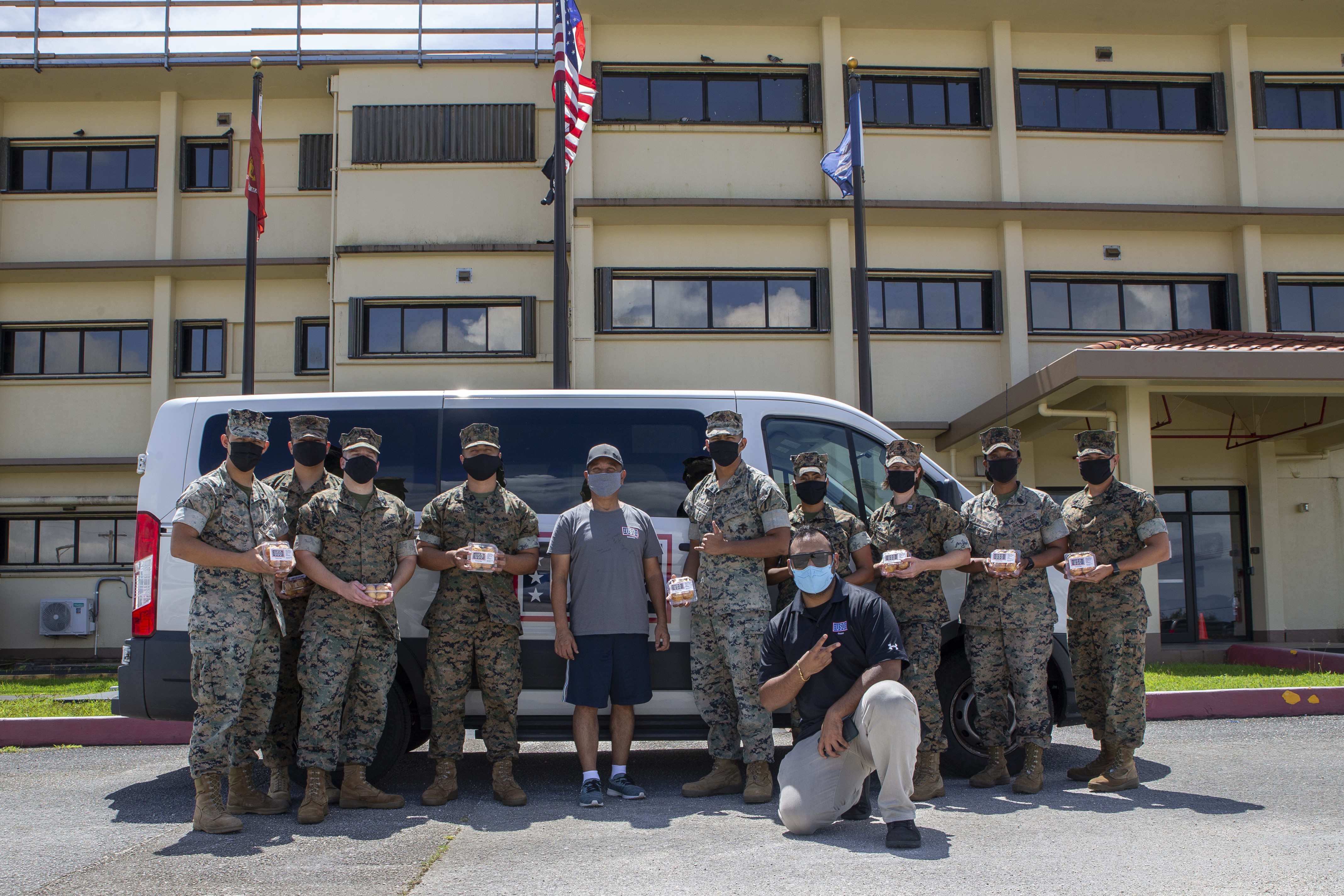 Volunteers with USO Tumon Bay pose for a photo with Marines assigned to Marine Corps Base (MCB) Camp, during a visit to MCB Camp Blaz, Oct. 14, 2021.