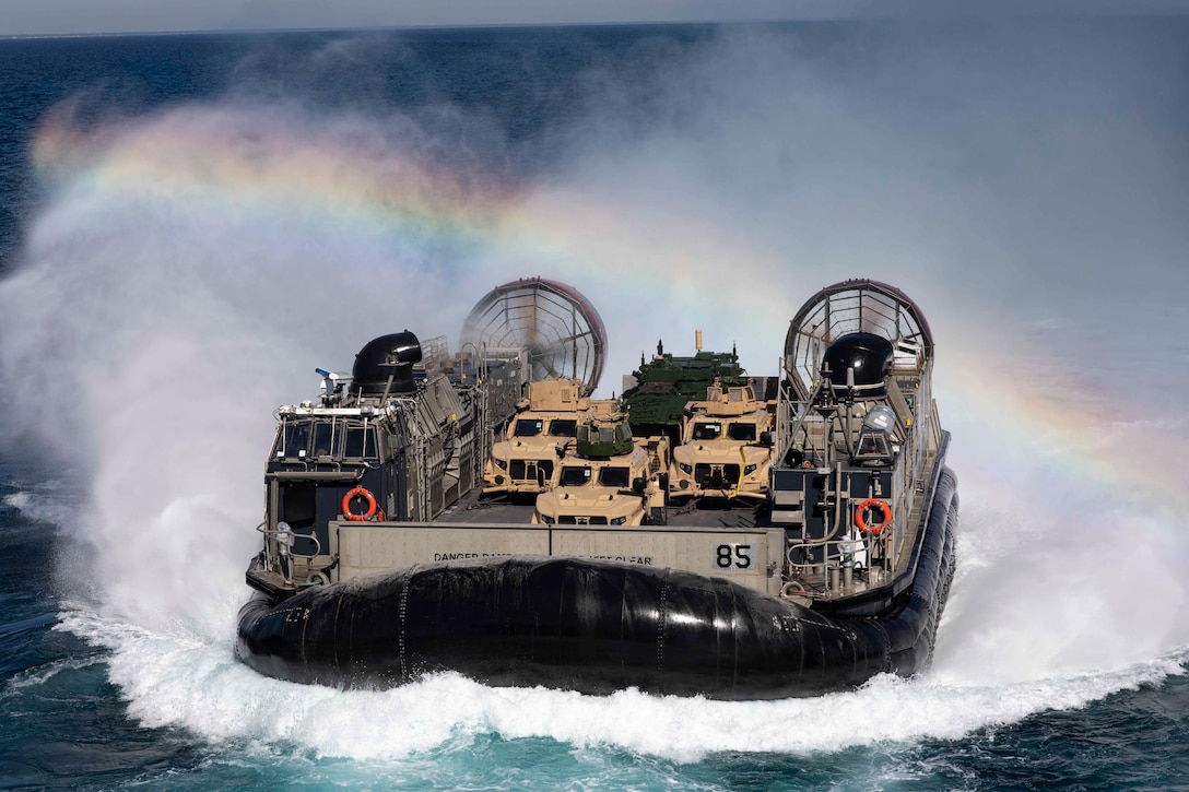 (211020-N-VM474-1024) ATLATIC OCEAN (Oct. 20, 2021) Landing Craft, Air Cushion 85, attached to Assault Craft Unit 4, transports Marine equipment from the shore of Camp Lejeune, North Carolina to the Wasp-class amphibious assault ship USS Kearsarge (LHD 3). Kearsarge is underway to support Phibron and Marine Expeditionary Unit Integration (PMINT). PMINT is an opportunity to train with embarked Marines in an integrated environment for amphibious and maritime operations including simulated beach raids, rescue operations, strait transits, and visit, board, search and seizure drills. (U.S. Navy photo by Mass Communication Specialist 3rd Class Gwyneth Vandevender)