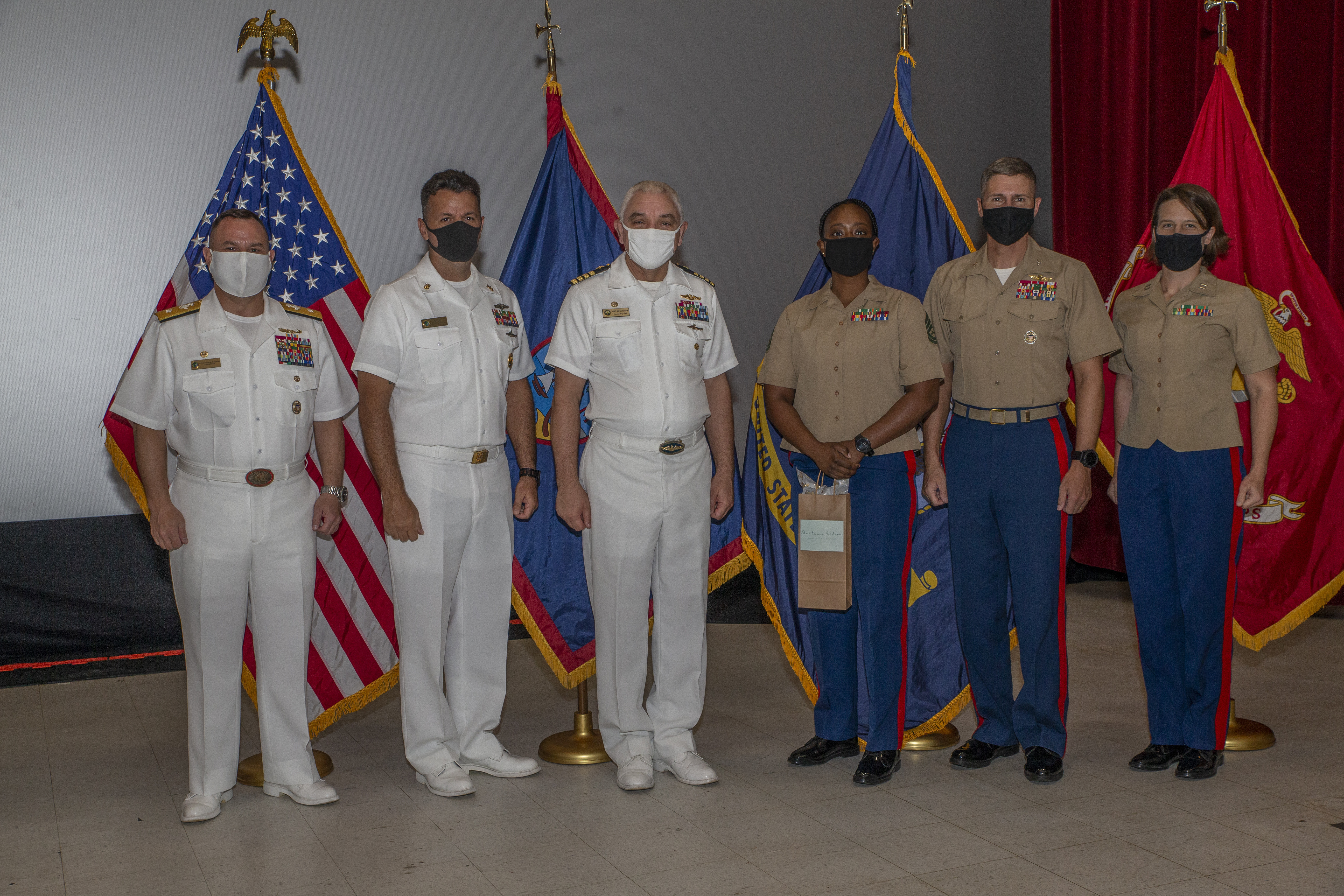 U.S. Marine Corps Gunnery Sgt. Shantavia Wilson, the Marine Corps Base (MCB) Camp Blaz ombudsman, poses for a photo with senior leaders from MCB Camp Blaz, U.S. Naval Base Guam (NBG) and Joint Region Marianas during an ombudsman appreciation awards ceremony on NBG, Oct. 15, 2021.