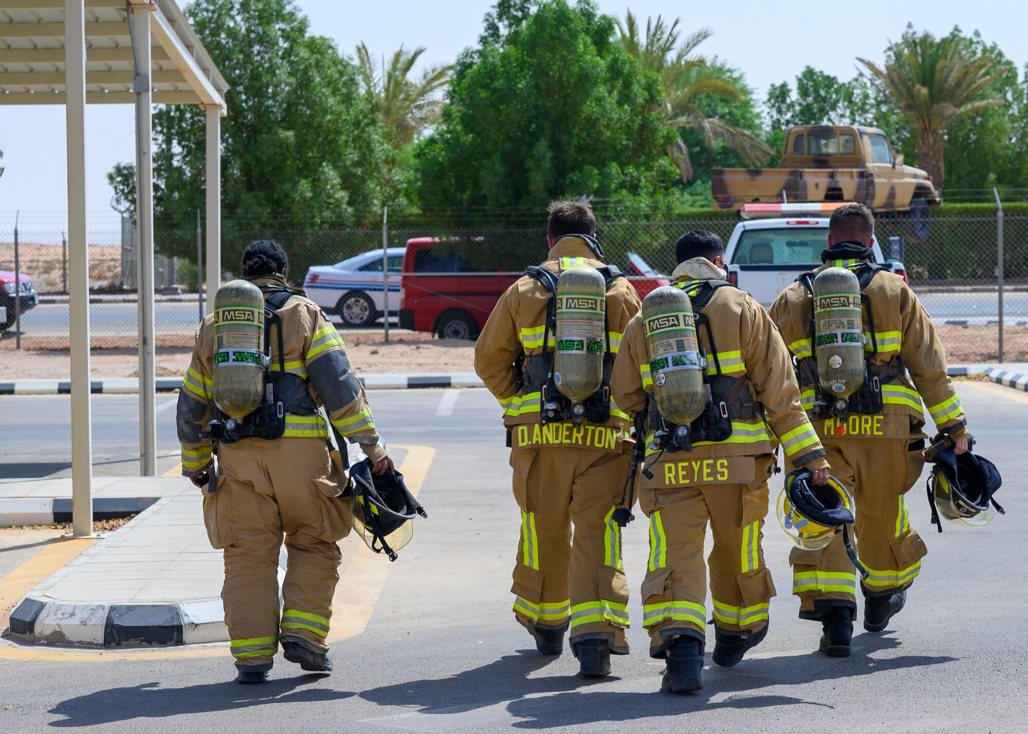 Firefighters from the 378th Expeditionary Civil Engineer Squadron return to the tactical vehicle after an emergency response bilateral exercise, Prince Sultan Air Base, Kingdom of Saudi Arabia, Sept. 6, 2021. The exercise was integral to maintaining a working relationship between RSAF and USAF first responders and ensuring seamless integration in case of future emergencies at PSAB. (U.S Air Force photo by Senior Airman Samuel Earick)