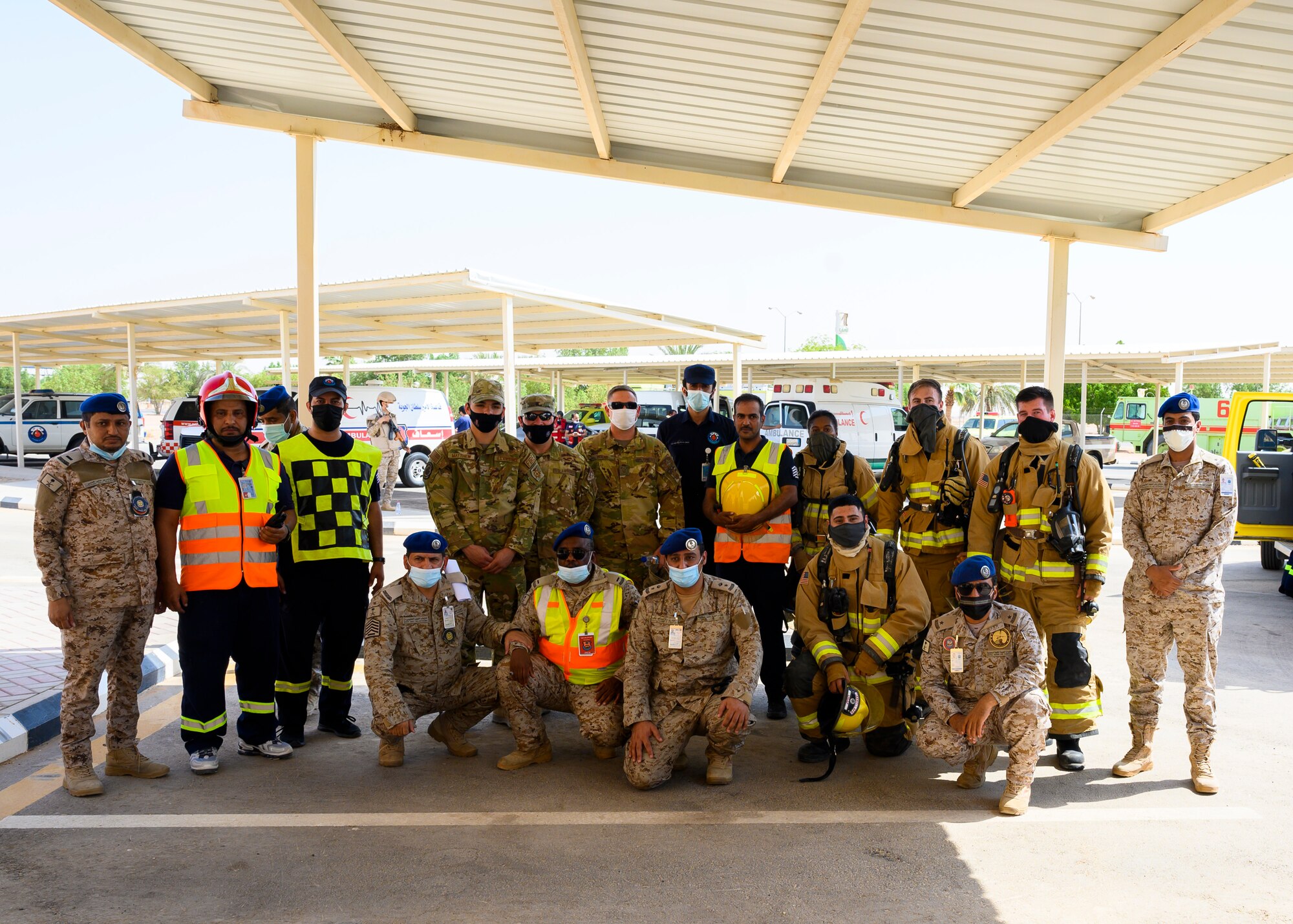Members of the 378th Expeditionary Civil Engineer Squadron and Royal Saudi Air Force pose for a group photo after an emergency response bilateral exercise, Prince Sultan Air Base, Kingdom of Saudi Arabia, Sept. 6, 2021. The exercise was integral to maintaining a working relationship between RSAF and USAF first responders and ensuring seamless integration in case of future emergencies at PSAB. (U.S Air Force photo by Senior Airman Samuel Earick)