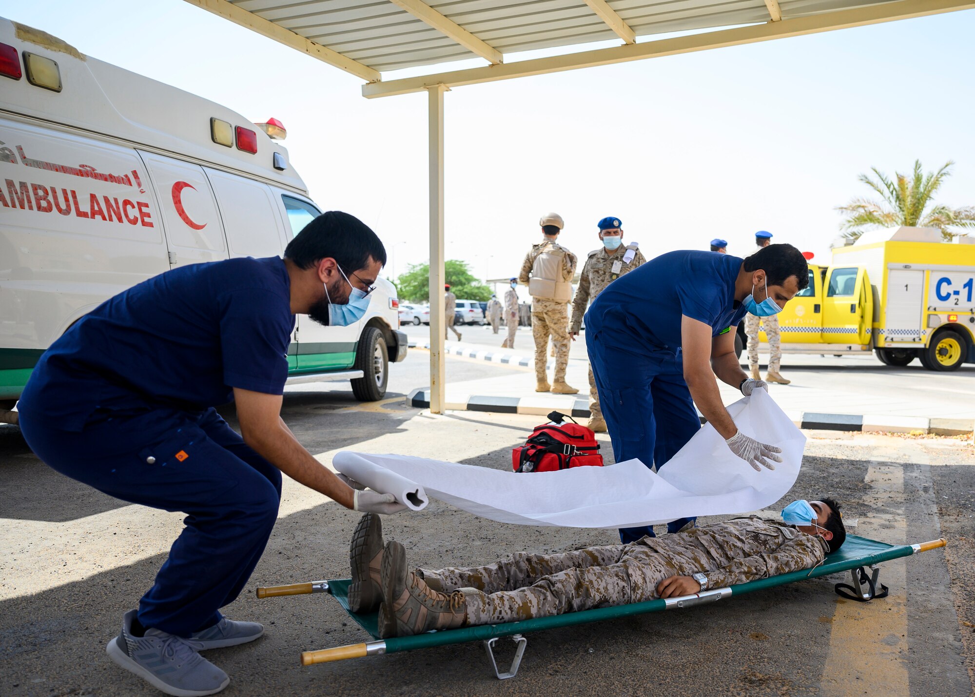 Royal Saudi Air Force medical personnel participate in an emergency response bilateral exercise with the U.S. Air Force 378th Expeditionary Civil Engineer Squadronfire department, Prince Sultan Air Base, Kingdom of Saudi Arabia, Sept. 6, 2021. The exercise was integral to maintaining a working relationship between RSAF and USAF first responders and ensuring seamless integration in case of future emergencies at PSAB. (U.S Air Force photo by Senior Airman Samuel Earick)