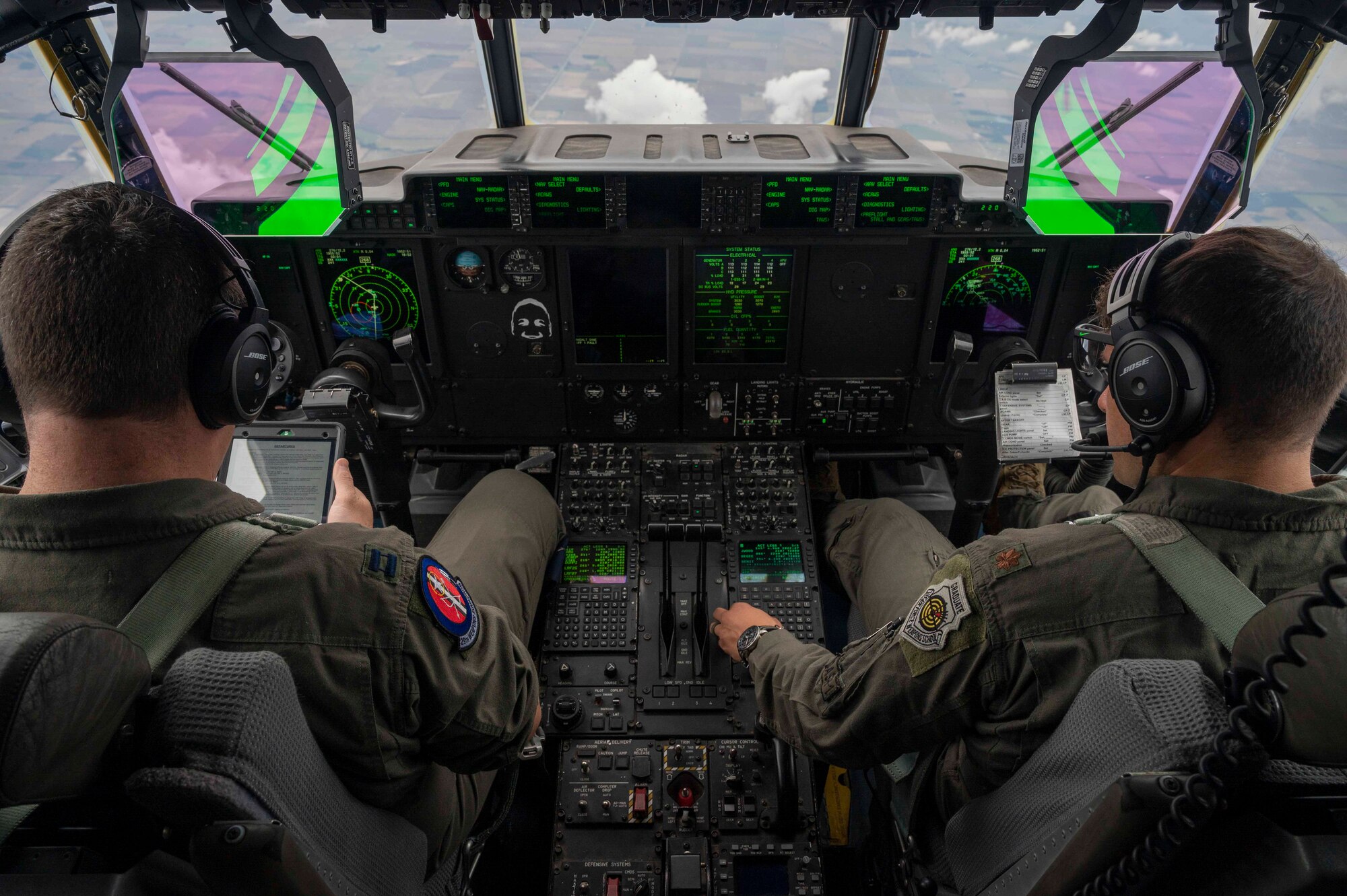 Two pilots fly a C-130J