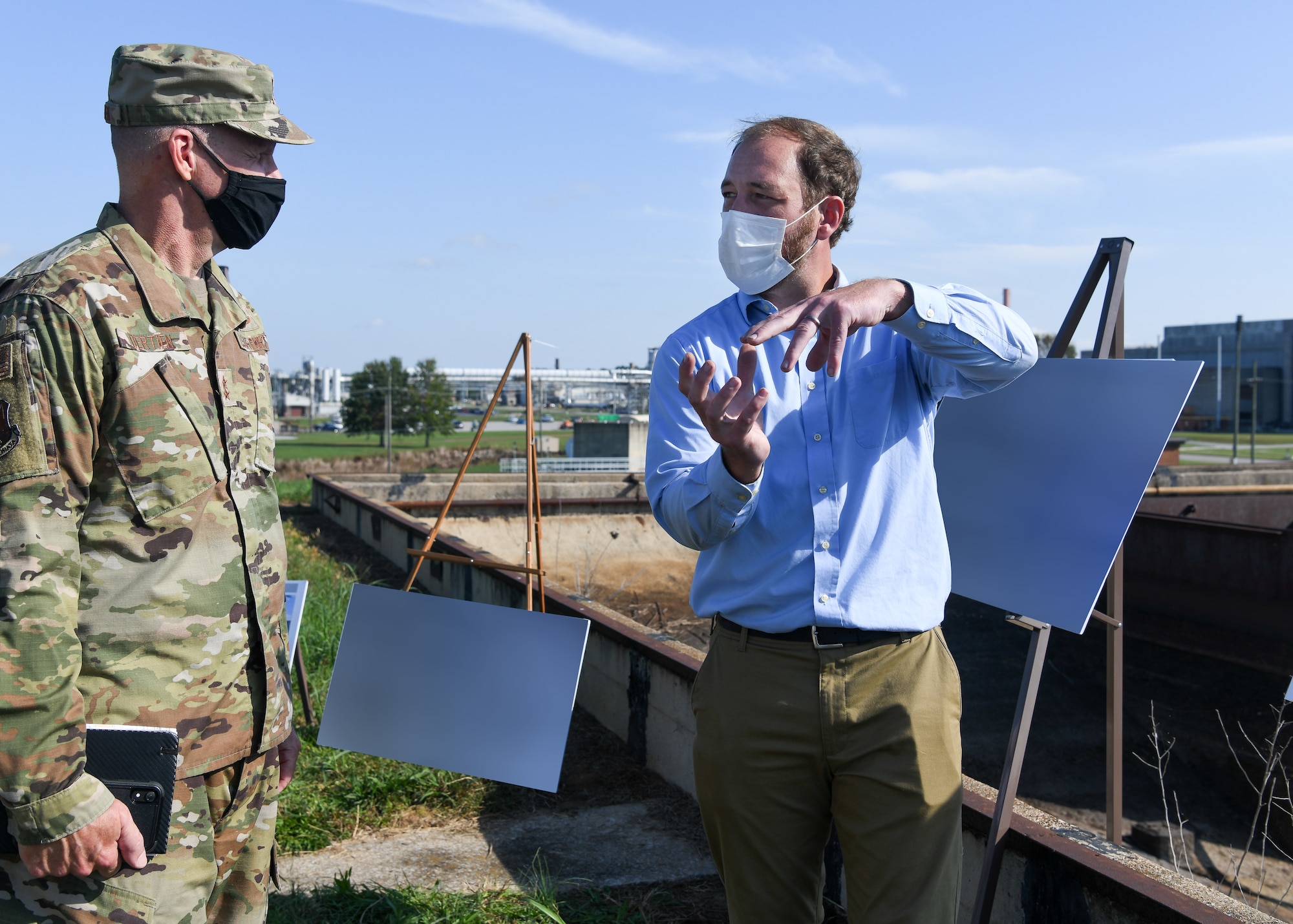 From right, Joshua Cooke, an Air Force senior utility manager at Arnold Air Force Base, speaks about the water utility system for the base with Maj. Gen. Evan Dertien, commander, Air Force Test Center, during Dertien's visit to Arnold Air Force Base, Oct. 14, 2021. (U.S. Air Force photo by Jill Pickett) (This image has been altered by obscuring posters for security reasons.)