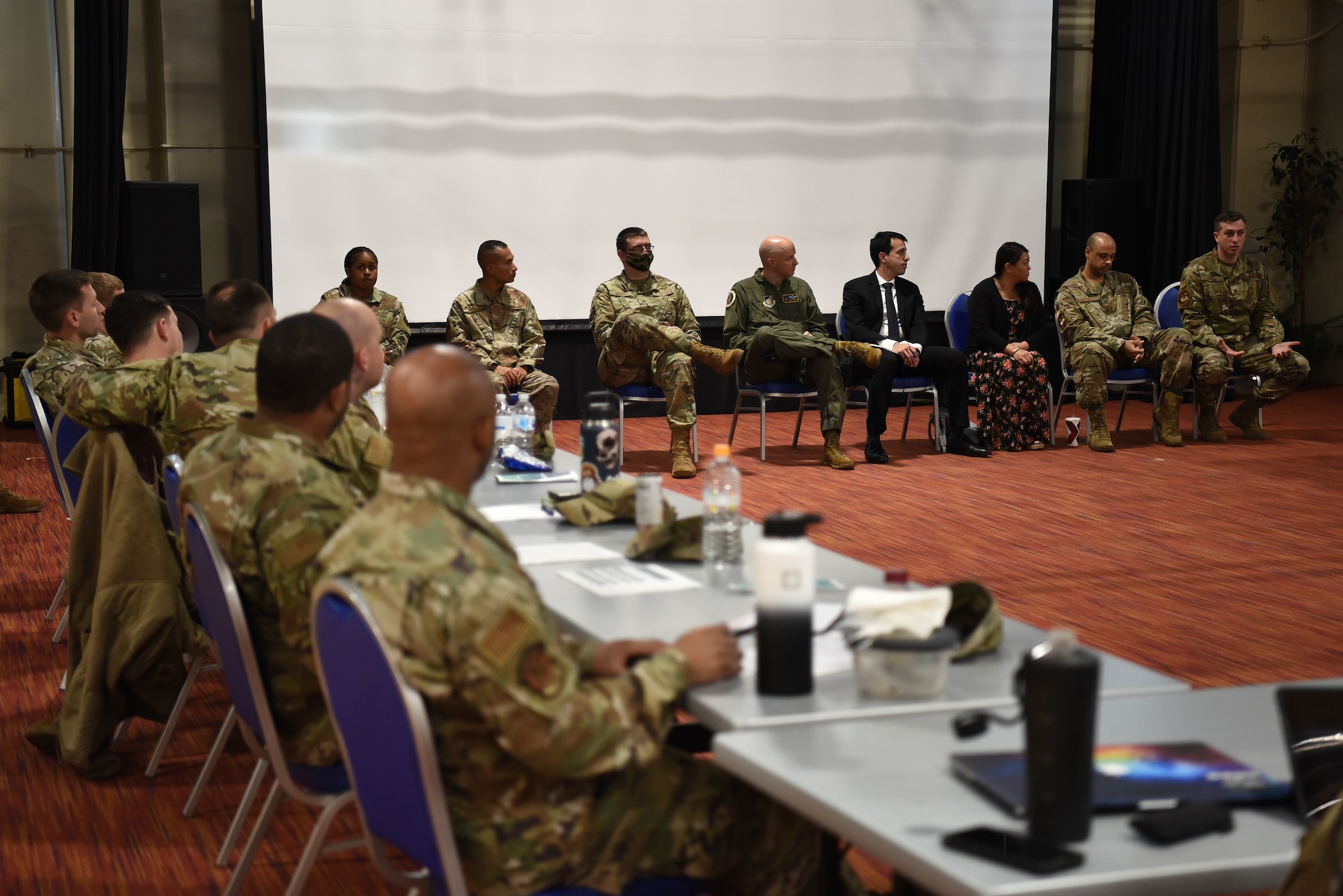 A panel of representatives of the resources on base talk to a class of military members.