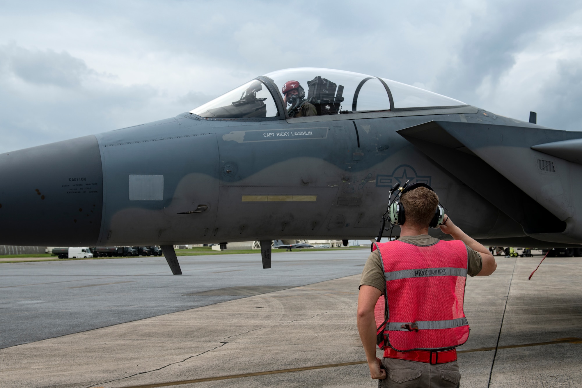 Airman 1st Class Connor Perkins, 67th Aircraft Maintenance Unit assistant dedicated crew chief, salutes a departing pilot during a super surge exercise at Kadena Air Base, Japan, Oct. 19, 2021. Increased flying operations during the super surge exercise provide valuable experience for maintenance personnel, simulating the fast-paced environment they would face in a deployed location. (U.S. Air Force photo by Senior Airman Jessi Monte)
