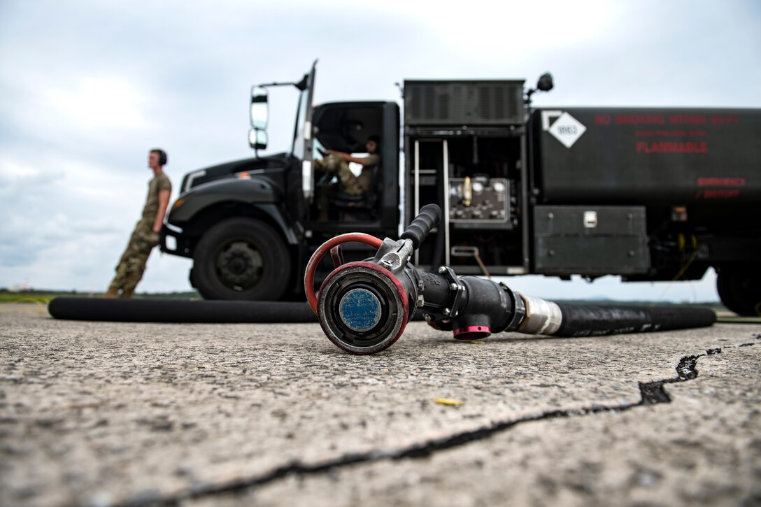 Airman 1st Class David Young, left, and Airman 1st Class Devin Lopez, 18th Logistics Readiness Squadron fuel distribution operators, wait for aircraft to arrive for hot pit refueling during a super surge exercise at Kadena Air Base, Japan, Oct. 19, 2021.  Surge operations provide aircrew and support personnel the opportunity to hone the skills necessary to maintain a ready force, capable of ensuring peace and stability in the Indo-Pacific region. (U.S. Air Force photo by Senior Airman Jessi Monte)