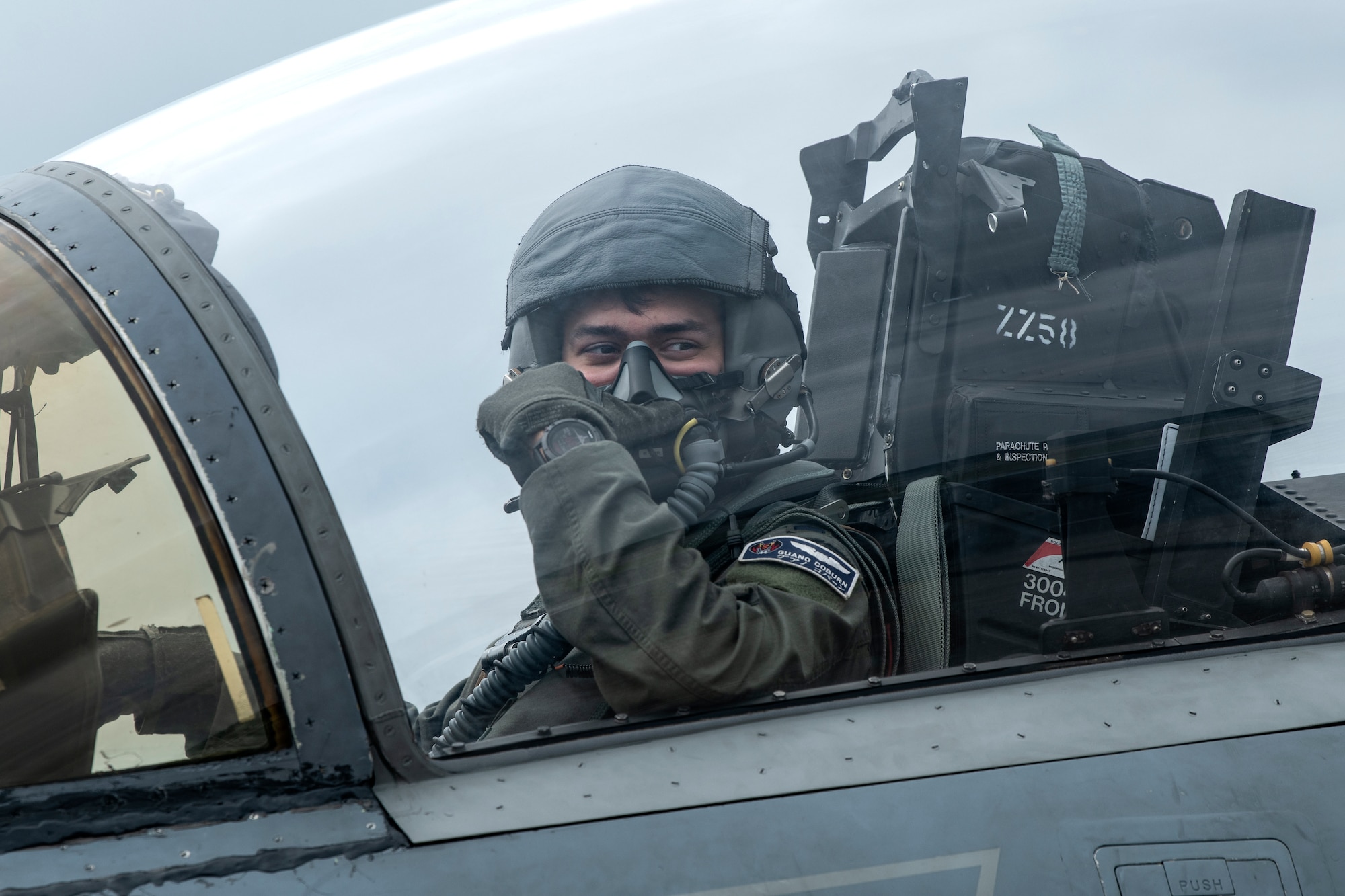 U.S. Air Force 1st Lt. Sebastian Coburn, 44th Fighter Squadron F-15C Eagle pilot, communicates with ground crew during a super surge exercise at Kadena Air Base, Japan, Oct. 19, 2021. 18th Wing fighter squadrons can fly more than 100 sorties a day while conducting surge operations, honing air-to-air tactics and advanced combat maneuvers. (U.S. Air Force photo by Senior Airman Jessi Monte)