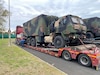 A contracted line haul truck driver inspects his load at a rest stop in route from Zutendaal, Belgium, to Leghorn Army Depot, Italy. To date, more than 150 trucks have transported over 2,000 pieces of Army Prepositioned Stock-2 equipment and vehicles from three APS-2 worksites north of the Alps to south of the Alps to support the new APS-2 theatre strategy and to provide capabilities to best support two Defense Department Combatant Commands. Over the next month, the APS-2 worksite at Leghorn Army Depot expects to receive about 4,000 more pieces of APS-2 equipment and vehicles. (Photo by Army Sgt. 1st Class Kavan Norris)
