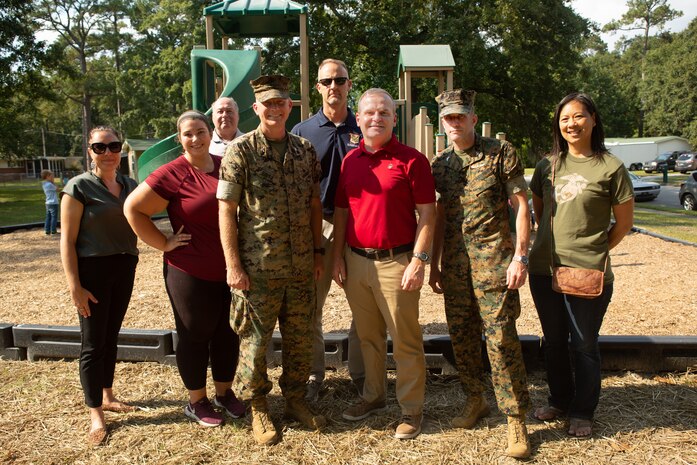 U.S. Marine Corps Col. Curtis Ebitz Jr., center, commanding officer of Marine Corps Air Station New River, and Col. Richard Joyce, right, commanding officer of Marine Aircraft Group 29, stand with Resident Advisory Board (RAB) members of Atlantic Marine Corps Communities after a park ribbon cutting ceremony on MCAS New River, Sept. 29, 2021.