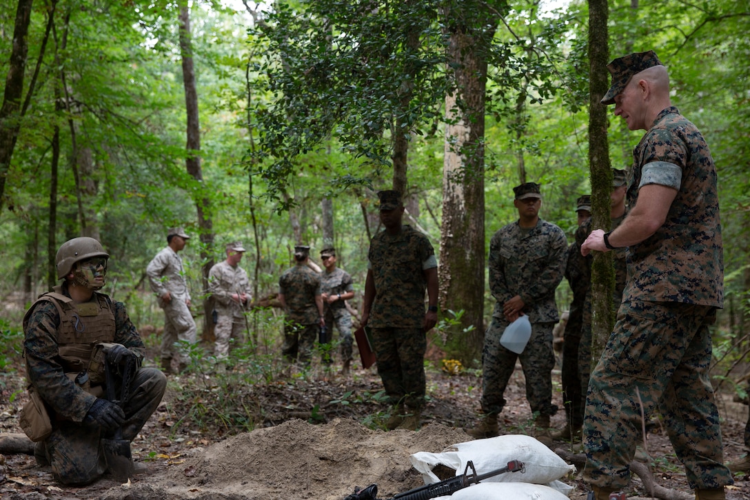 U.S. Marine Corps Sgt. Maj. Troy E. Black, right, Sergeant Major of the Marine Corps, speaks with U.S. navy hospital man Wyatt Phillipson, a student with the Field Medical Training Battalion, at Camp Devil Dog, North Carolina, Oct. 6, 2021.