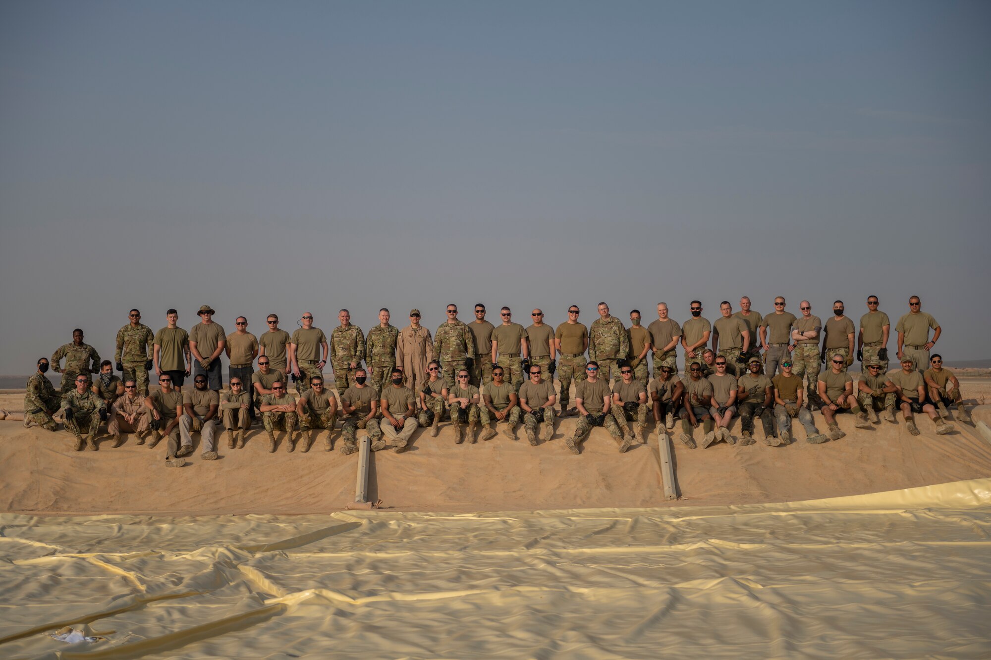 U.S. Airmen with the 332nd Air Expeditionary Wing spread out a collapsible fabric tank