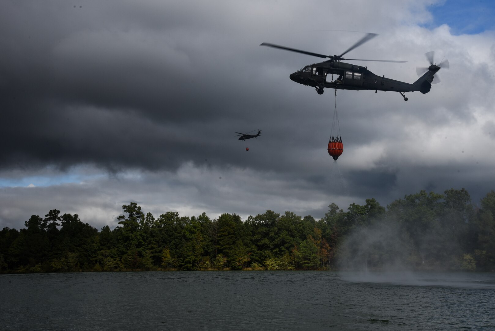 Virginia Army National Guard flight crews conduct water bucket training with UH-60 Black Hawk helicopters Oct. 12, 2021, at a training area in Chesterfield, Virginia. These Soldiers are scheduled to deploy to Kosovo with the 2nd Battalion, 224th Aviation Regiment, 29th Infantry Division in early 2022, where firefighting capabilities may be needed.