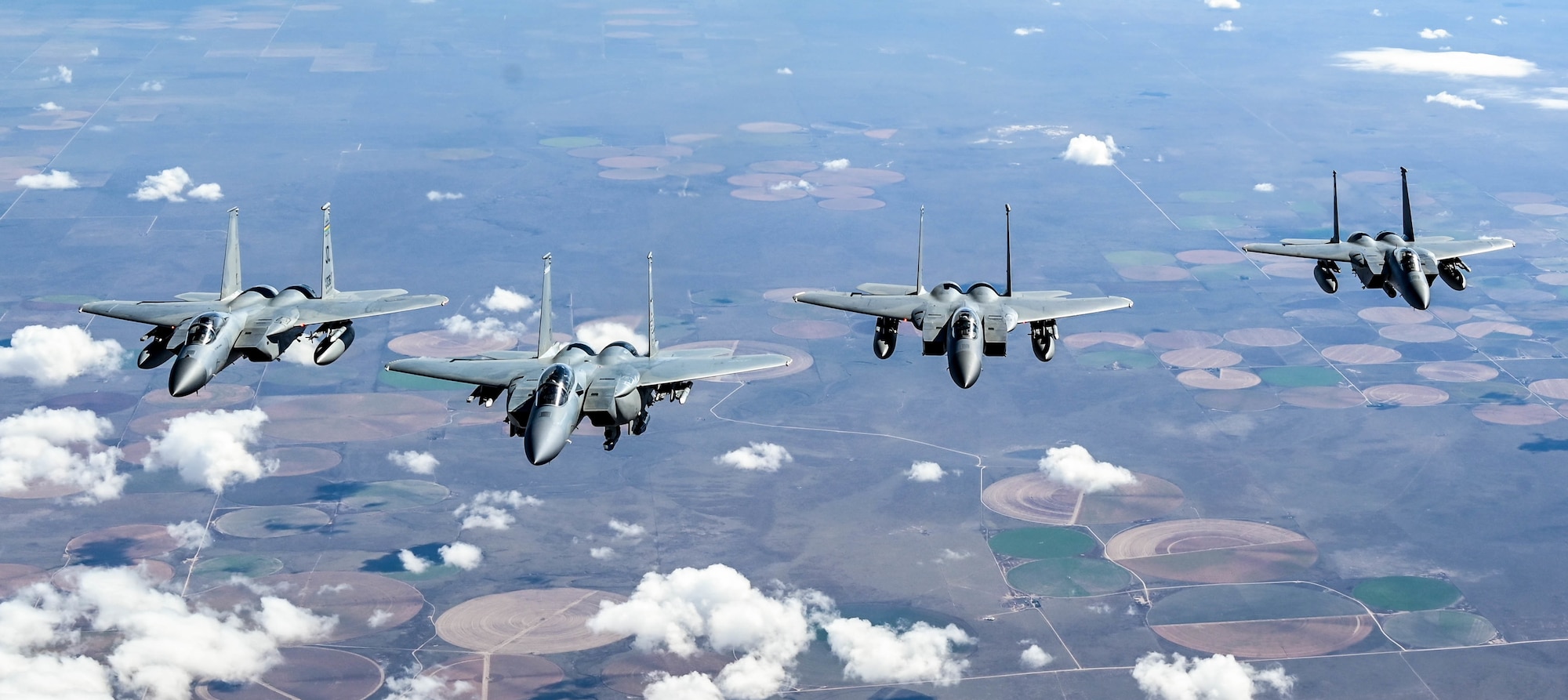 Three F-15Cs and an F-15EX assigned to the 85th Test and Evaluation Squadron, Eglin Air Force Base, Florida, fly in formation behind a KC-135 assigned to the 465th Air Refueling Squadron, Tinker AFB, Oklahoma, Oct. 15, 2021. (U.S. Air Force photo by 2nd Lt. Mary Begy)