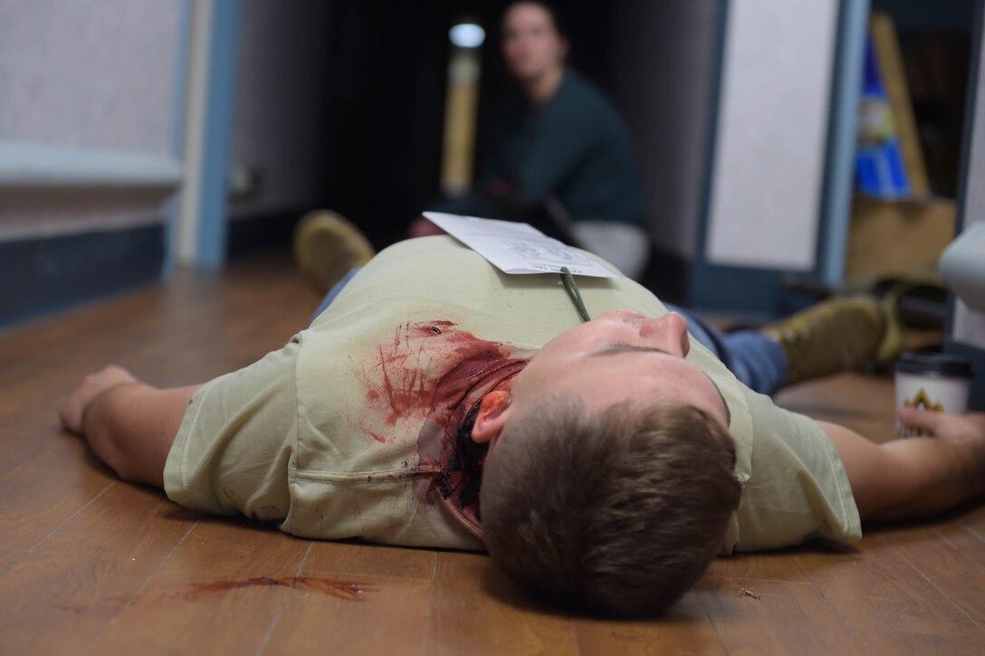 A photo of an airman laying on the ground.
