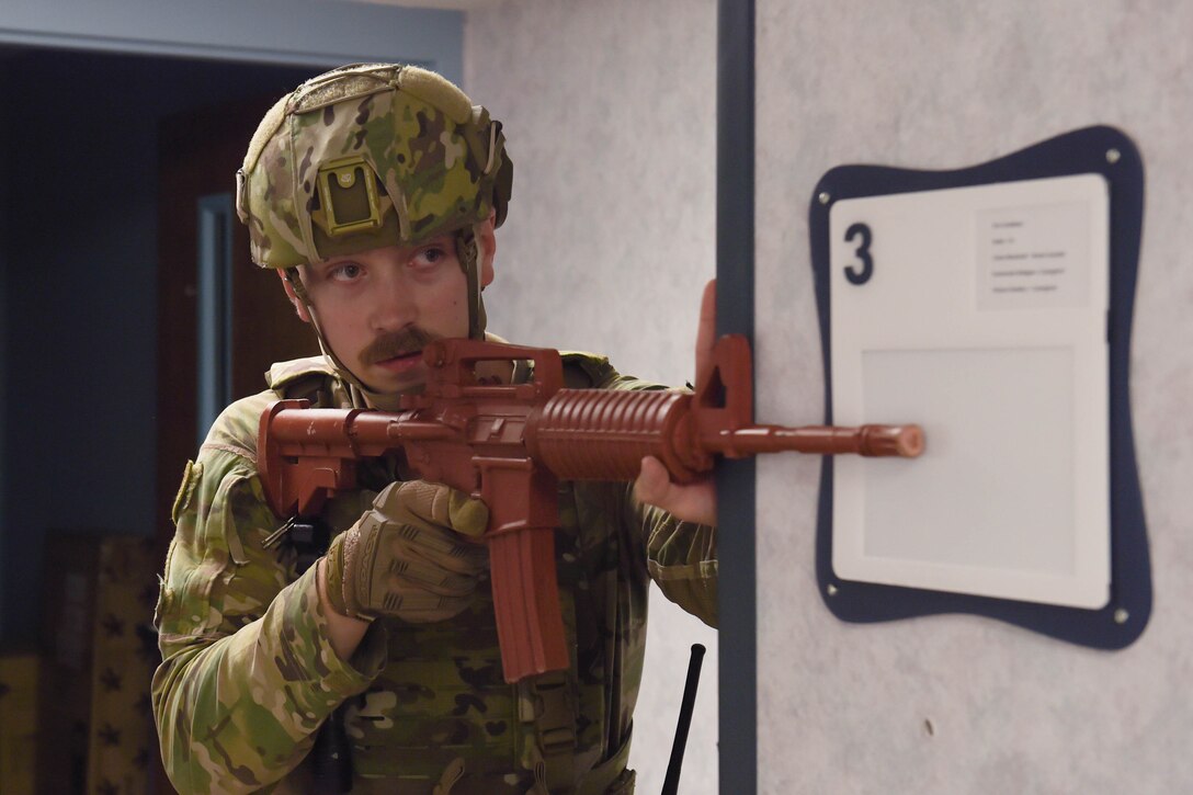 A photo of Airman holding weapon.