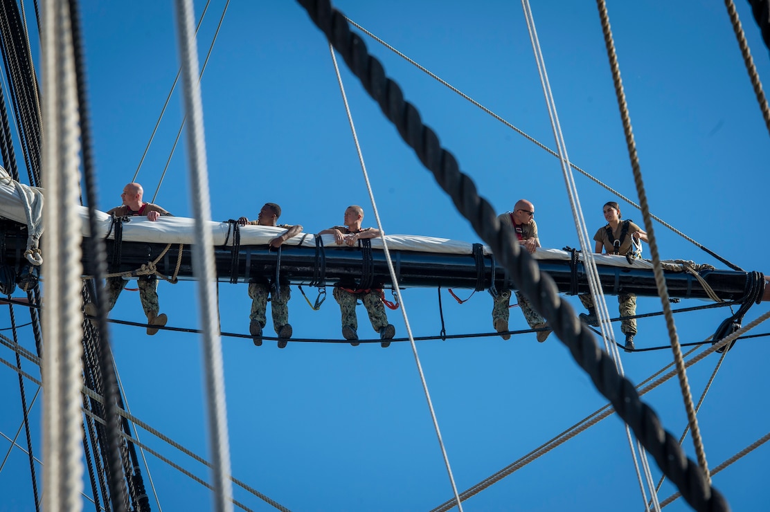 Petty officers first class, selected for promotion to chief petty officer, climb on main topyard aboard USS Constitution during Chief Petty Officer Heritage Weeks.