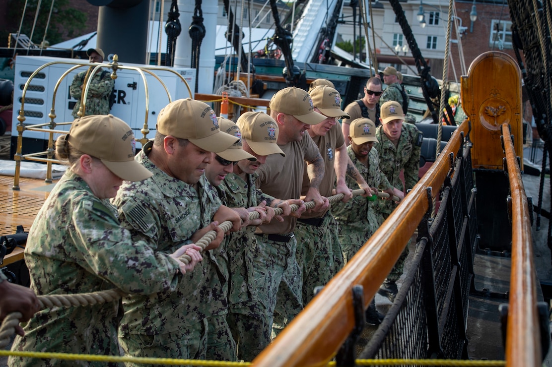 Petty officers first class, selected for promotion to chief petty officer, handle line aboard USS Constitution during Chief Petty Officer Heritage Weeks.