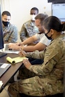 Daniel Rogers,. U.S. Army Finical Management Command Operation Support Team financial management systems trainer, evaluates Pfc. Joseph Perez, Pfc. Shane Constant and Pfc. San Juanita Gomez, financial management technicians assigned to Alpha Detachment, 24th Financial Management Support Unit, Division Special Troops Battalion, 3rd Division Sustainment Brigade, 3rd Infantry Division, during pre-deployment certification on Fort Stewart, Georgia, Sept. 29, 2021. The unit has been conducting certification throughout the month of September to prepare the unit to support the U.S. Central Command. The evaluation differs from finance’s ordinary training operations due to its focus on the specific skills and knowledge they will need to support their upcoming deployment. (U.S. Army photo by Sgt. Laurissa Hodges)