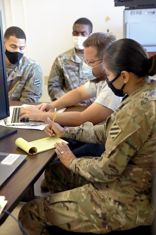 Daniel Rogers,. U.S. Army Finical Management Command Operation Support Team financial management systems trainer, evaluates Pfc. Joseph Perez, Pfc. Shane Constant and Pfc. San Juanita Gomez, financial management technicians assigned to Alpha Detachment, 24th Financial Management Support Unit, Division Special Troops Battalion, 3rd Division Sustainment Brigade, 3rd Infantry Division, during pre-deployment certification on Fort Stewart, Georgia, Sept. 29, 2021. The unit has been conducting certification throughout the month of September to prepare the unit to support the U.S. Central Command. The evaluation differs from finance’s ordinary training operations due to its focus on the specific skills and knowledge they will need to support their upcoming deployment. (U.S. Army photo by Sgt. Laurissa Hodges)