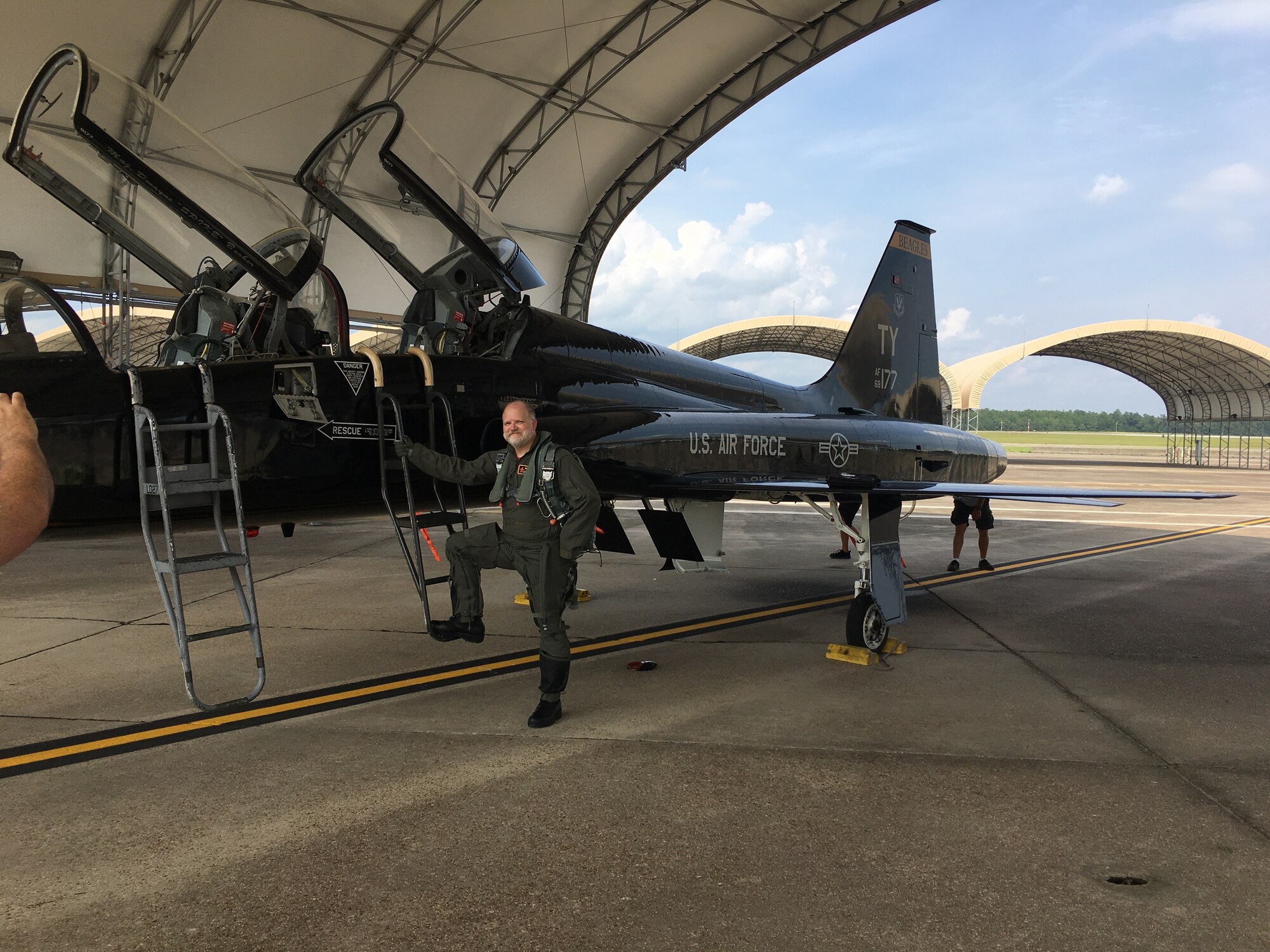 An incentive flyer poses by a T38