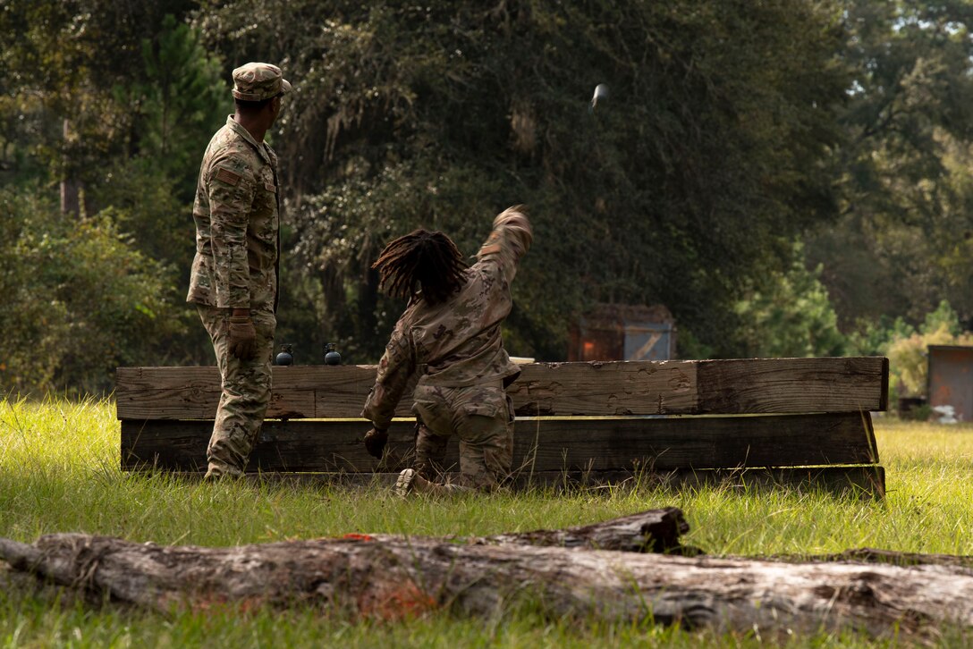 A photo of an Airman throwing a grenade.