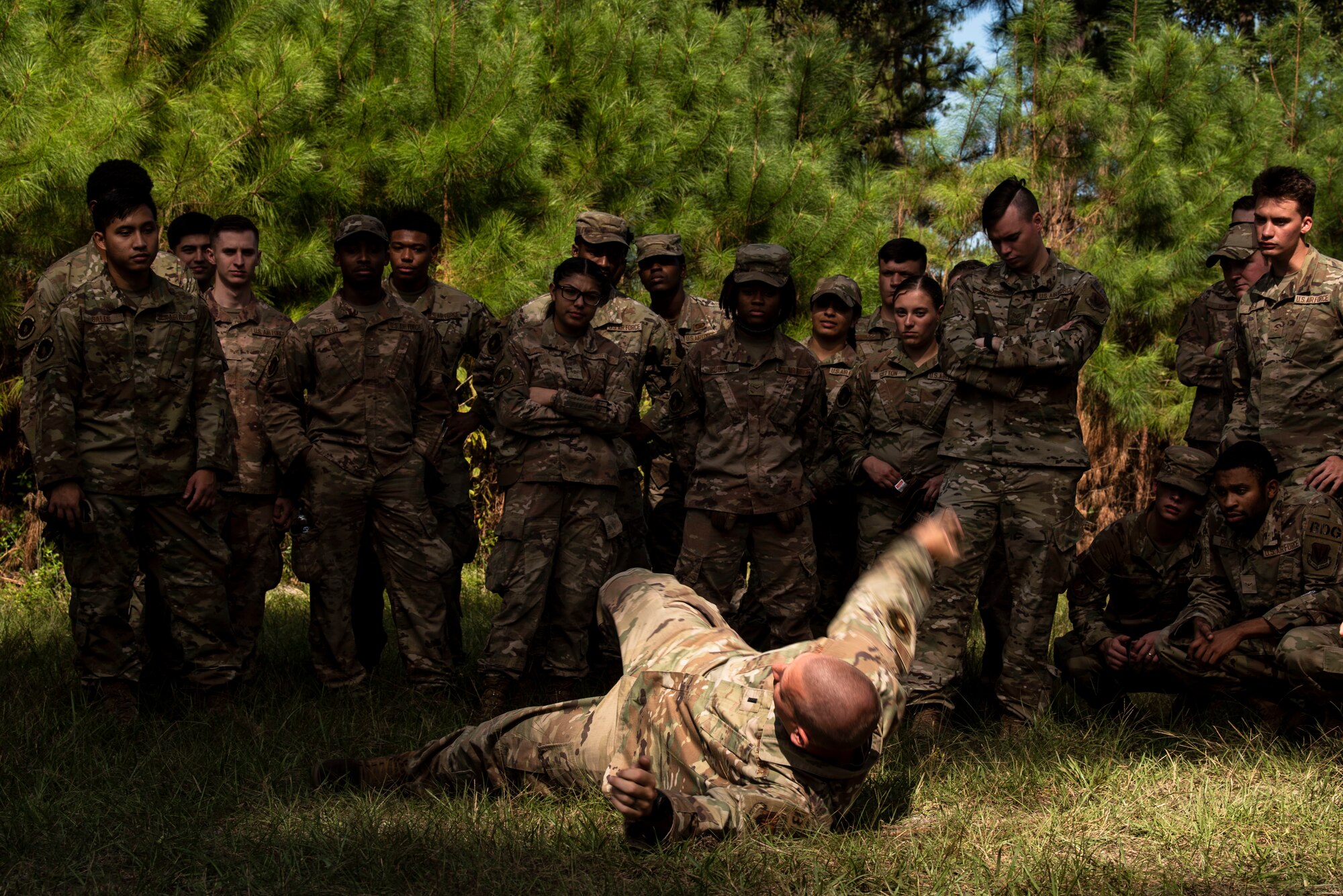 A photo of an Airman demonstrating how to throw a grenade.