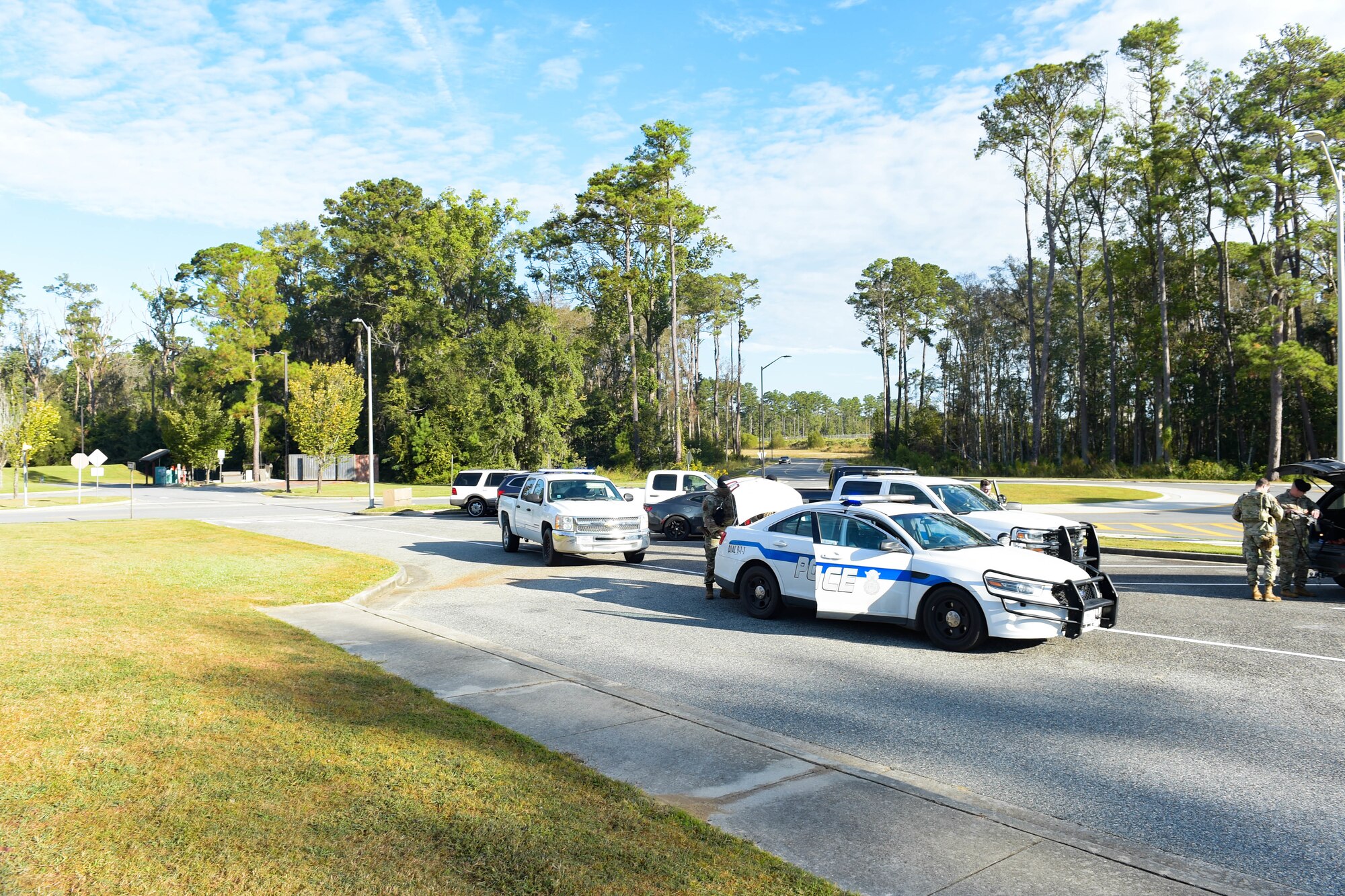 A photo of Airmen getting out of police cars.