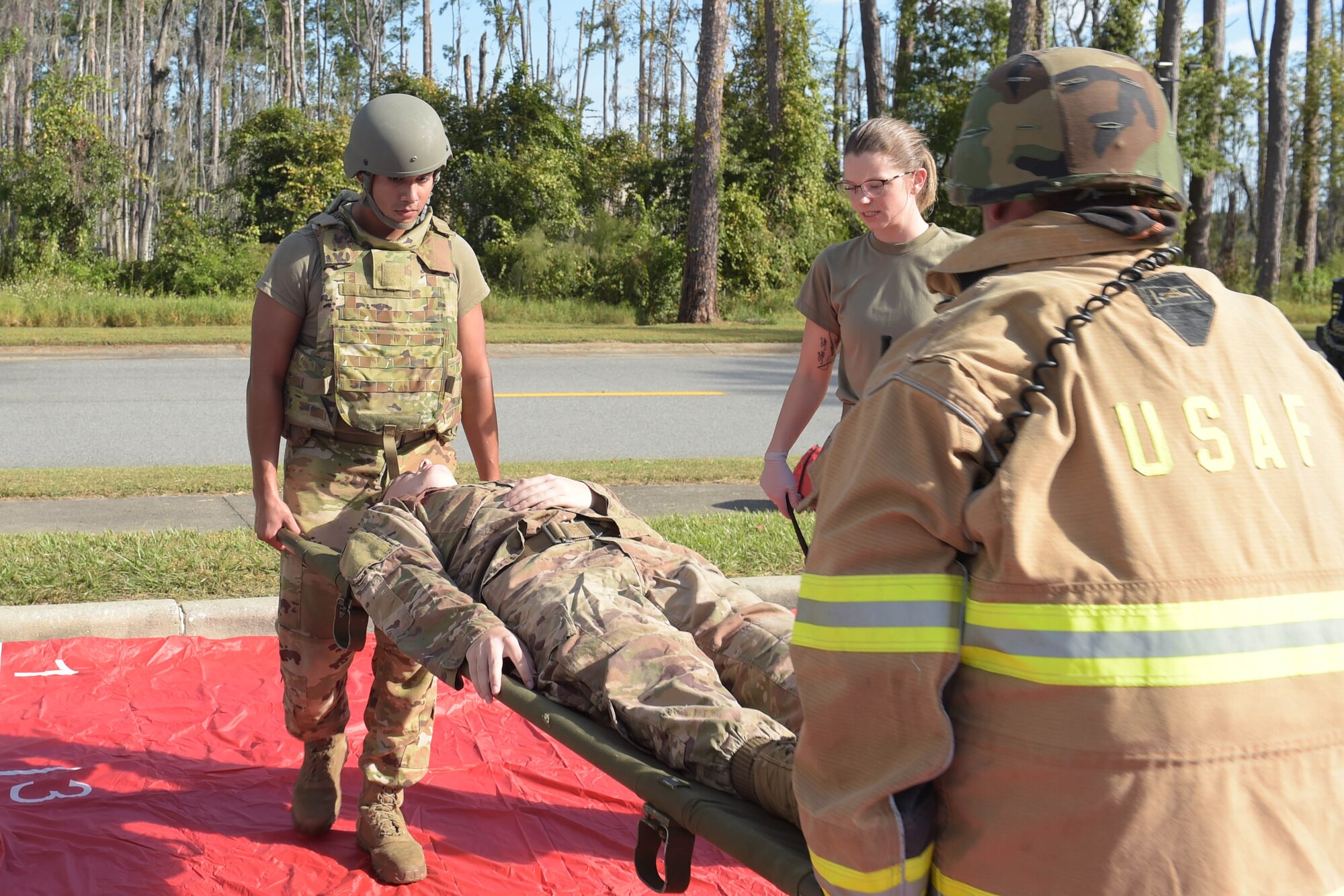 A photo of Airmen carrying an Airman.