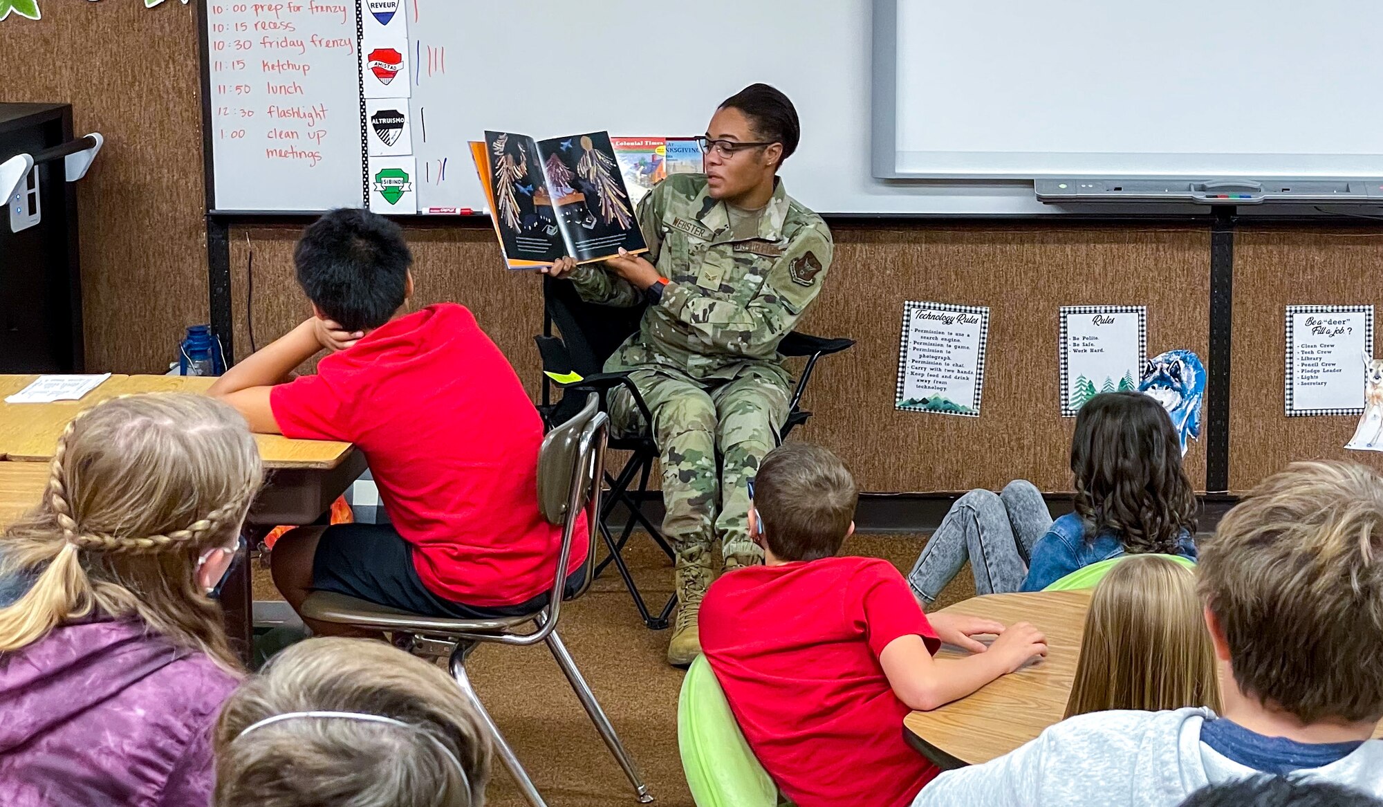 Senior Airman Erica Webster, a reservist in the 419th Fighter Wing, reads a picture book to Mrs. Berensen’s fifth-grade class at Layton Elementary