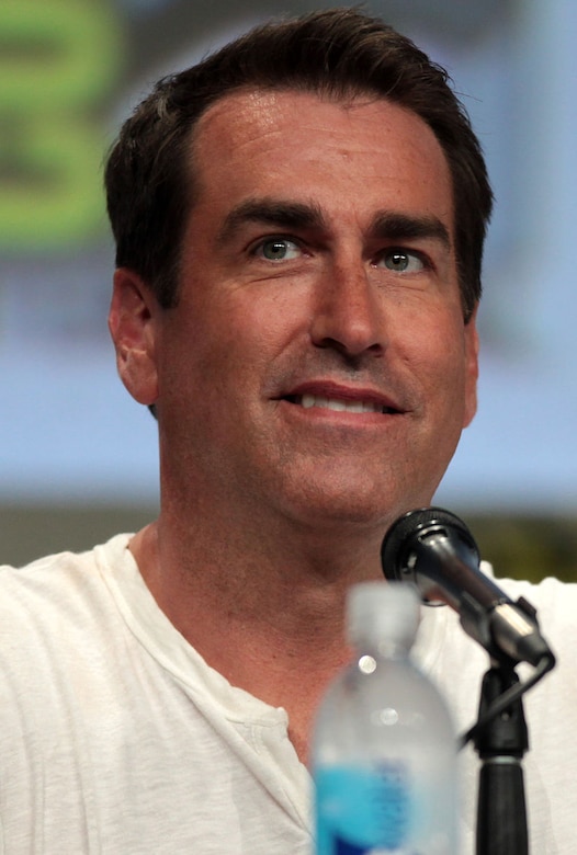 A man sits in front of a microphone.