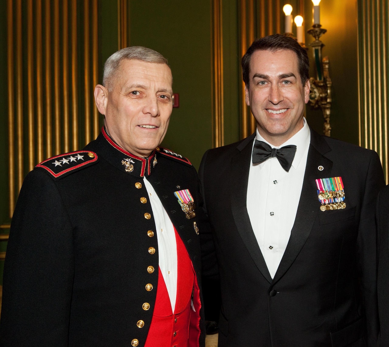 Two men in formal attire pose for a photo.