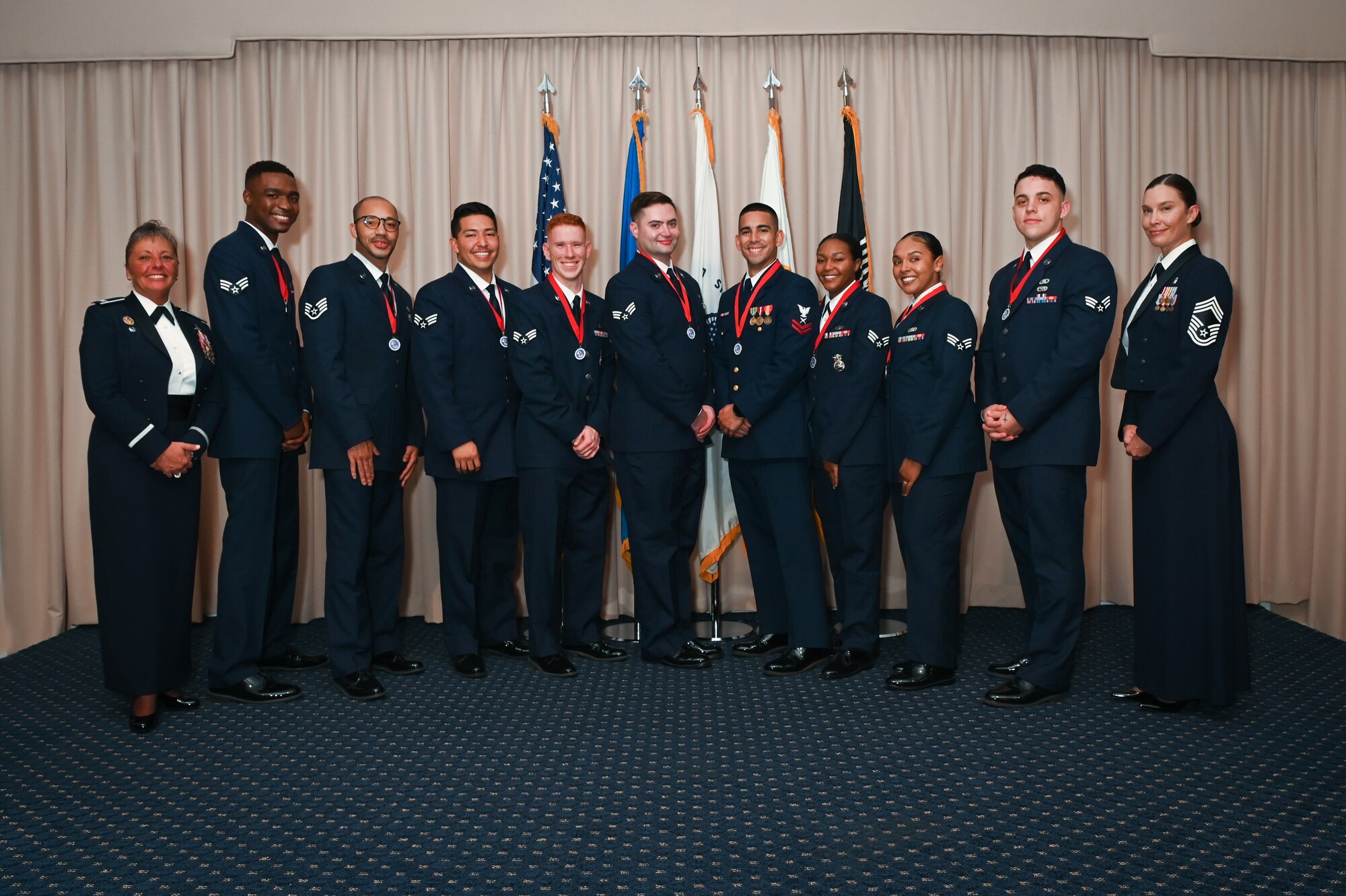 Airman Leadership School Class 21H graduates stand for a photo with installation leadership