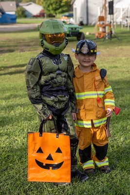 Two children posing for photo in Halloween costumes.