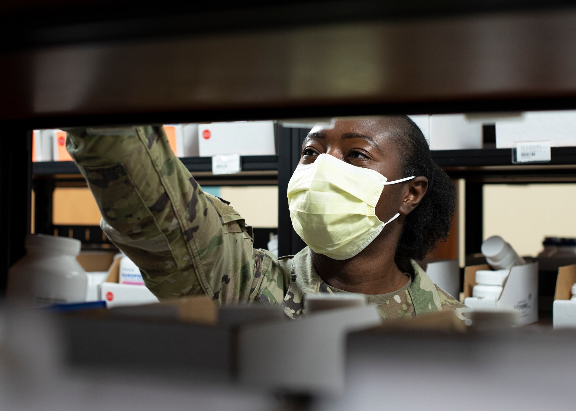 U.S. Air Force Senior Airman Aisha Jennings, 6th Medical Support Squadron pharmacy technician, reaches for a prescription at MacDill Air Force Base, Oct. 20, 2021.