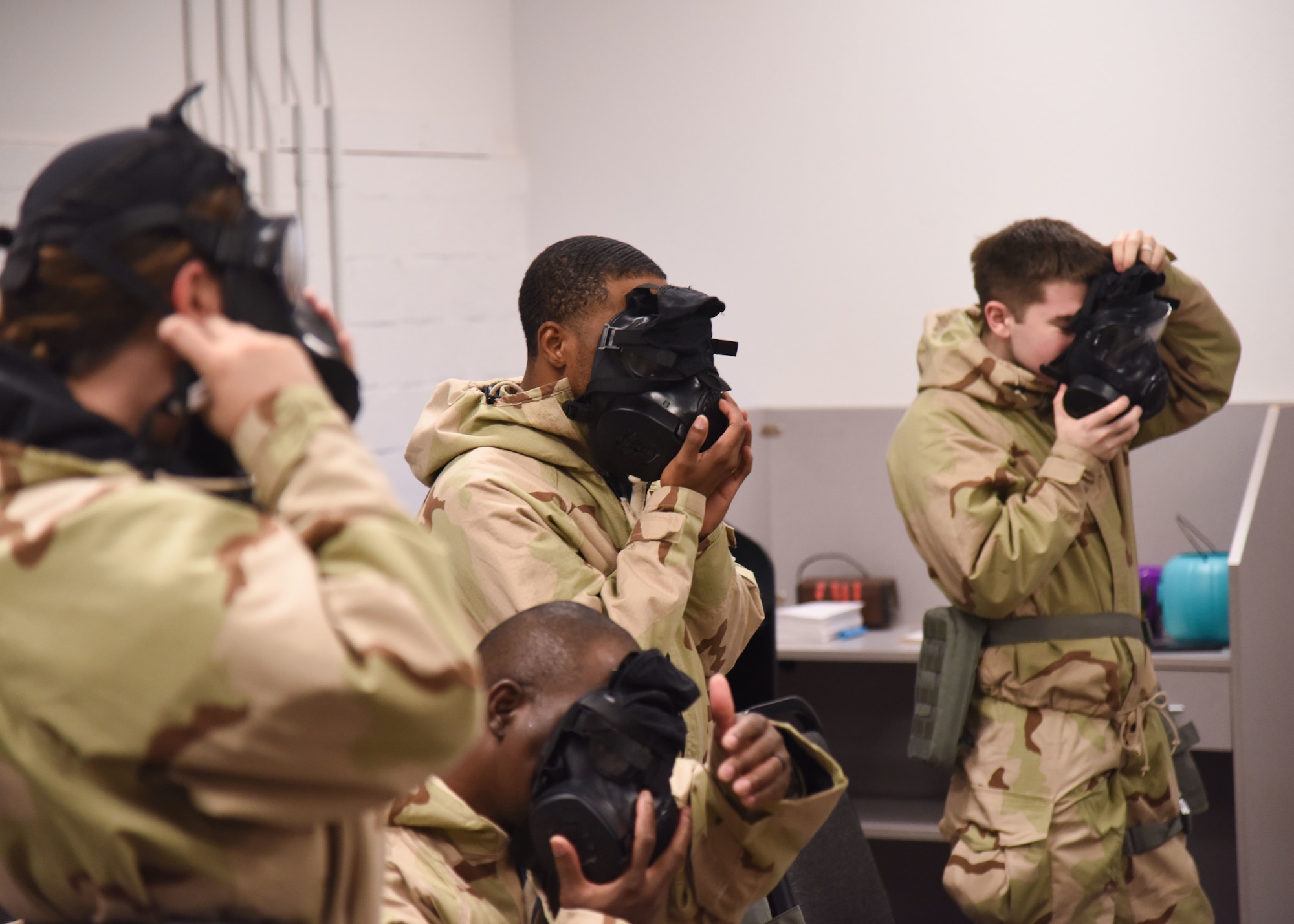 Goodfellow members don gasmasks during an Expeditionary Readiness Training on Goodfellow Air Force Base.