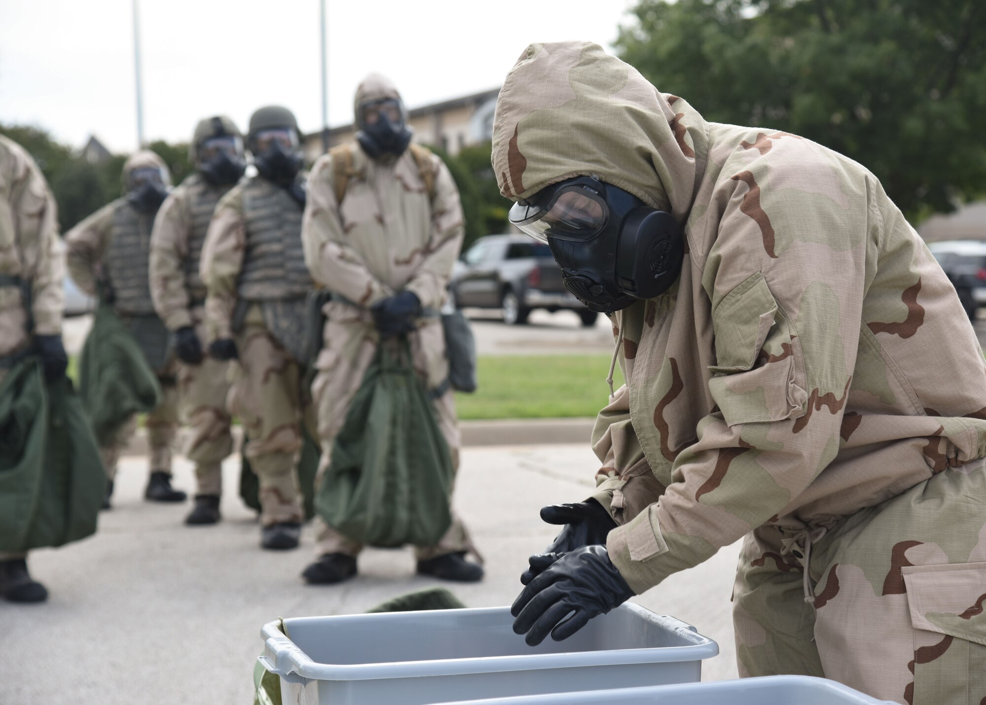 Goodfellow members simulate a decontamination process during an Expeditionary Readiness Training on Goodfellow Air Force Base.