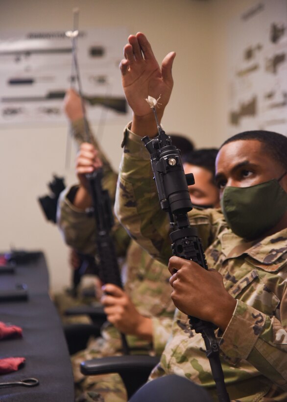 Goodfellow members clean weapons in a combat arms course during an Expeditionary Readiness Training on Goodfellow Air Force Base.