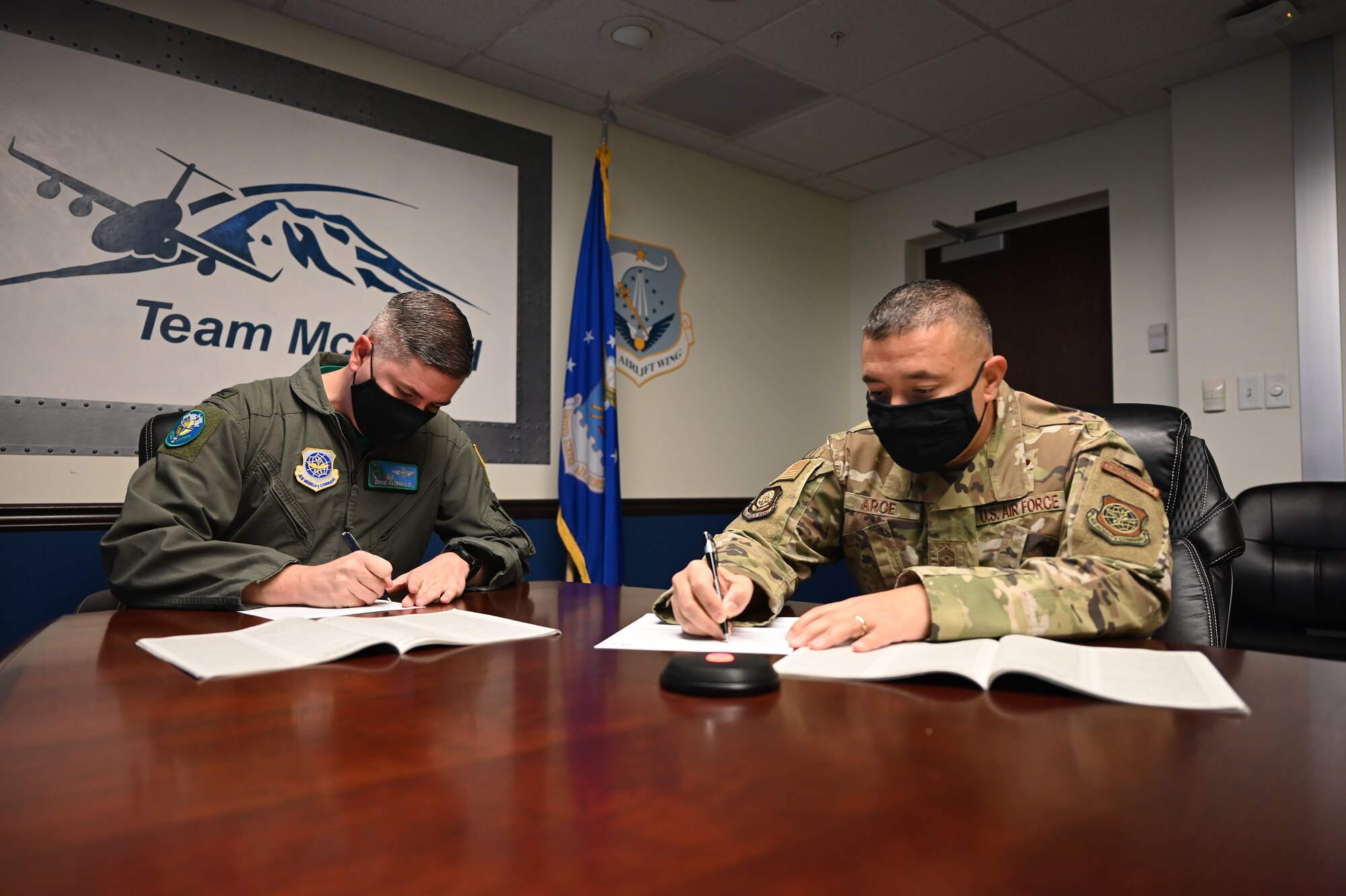 U.S. Air Force Col. David Fazenbaker, 62nd Airlift Wing commander, and Chief Master Sgt. Joseph Arce, 62nd AW command chief, complete their Combined Federal Campaign (CFC) pledge forms at Joint Base Lewis-McChord, Washington, Oct. 22, 2021. The Combined Federal Campaign (CFC) is one of the largest and most successful workplace fundraising campaigns in the world. Team McChord federal employees may donate through paper pledge forms, online portal or mobile CFC Giving App. (U.S. Air Force photo/Master Sgt. Julius Delos Reyes)