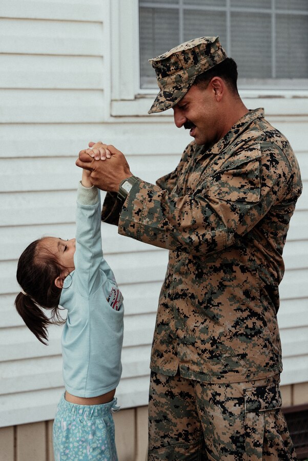U.S. Marine Corps Lance Cpl. Nima H. Najafabadi, a machine gunner with 3rd Battalion, 6th Marine Regiment, plays with an Afghan child on Fort Pickett, Virginia, Oct. 13, 2021. Najafabadi, originally from Shiraz, Iran, came to the United States when he was 8 years old. Now, he is grateful for the opportunity to help families who are in a similar position that he was in 20 years ago. The Department of Defense, through U.S. Northern Command, and in support of the Department of Homeland Security, is providing transportation, temporary housing, medical screening, and general support for at least 50,000 Afghan evacuees at suitable facilities, in permanent or temporary structures, as quickly as possible. This initiative provides Afghan personnel essential support at secure locations outside Afghanistan. (U.S. Marine Corps photo by Sgt. Corey Mathews)