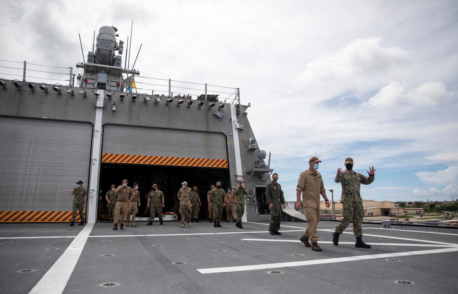 211021-N-LI768-2089 APRA HARBOR, Guam (Oct. 21, 2021) – Sailors from the German Navy frigate Bayern (F 217) tour the flight deck of the Independence-variant littoral combat ship USS Tulsa (LCS 16). Tulsa, part of Destroyer Squadron Seven, is on a rotational deployment, operating in the U.S. 7th Fleet area of operations to enhance interoperability with partners and serve as a ready-response force in support of a free and open Indo-Pacific region. (U.S. Navy photo by Mass Communication Specialist 1st Class Devin M. Langer)