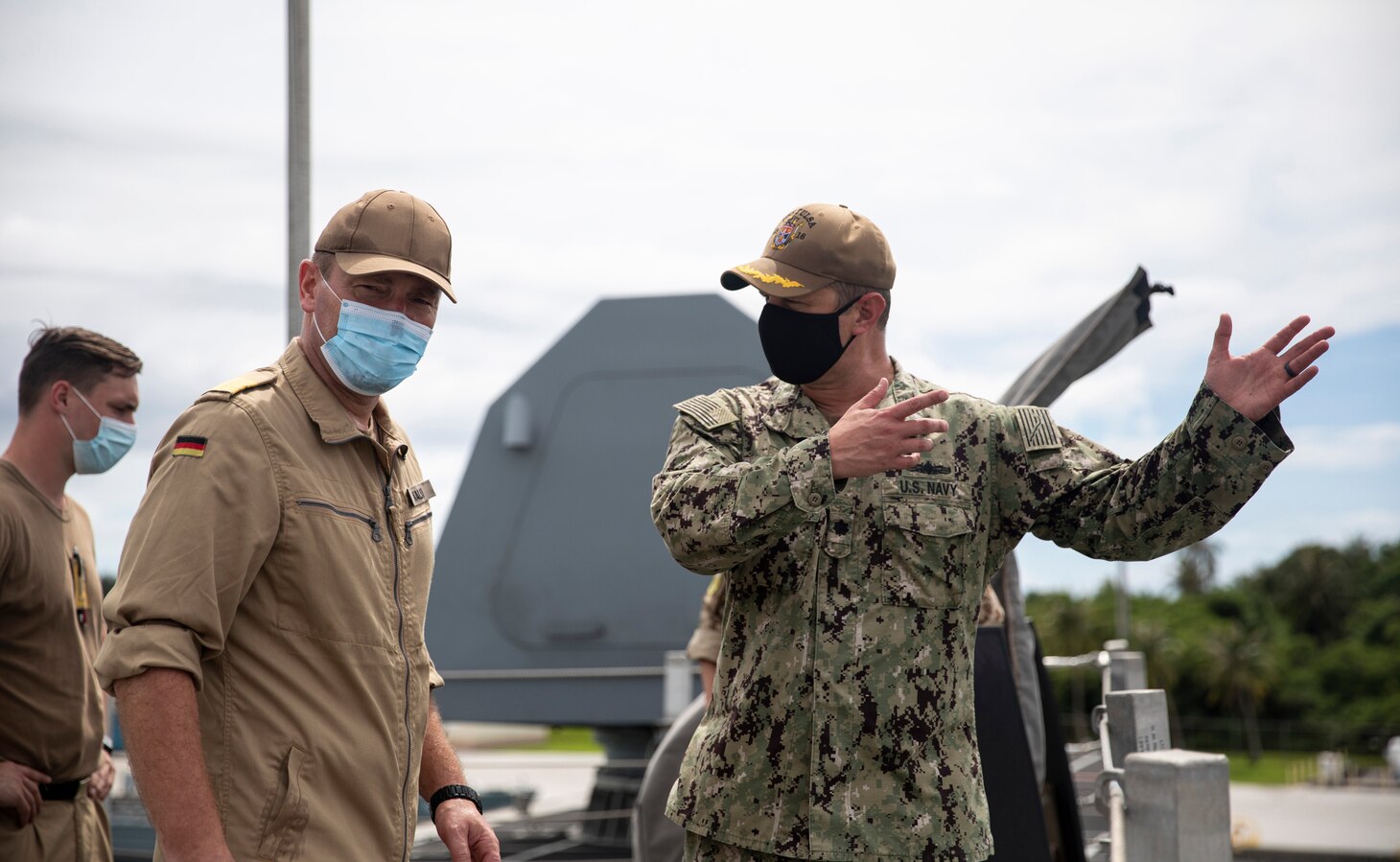 211021-N-LI768-2079 APRA HARBOR, Guam (Oct. 21, 2021) – Cmdr. Travis Dvorak, the commanding officer of the Independence-variant littoral combat ship USS Tulsa (LCS 16), describes Tulsa’s capabilities to Cmdr. Tilo Kalski, the commanding officer of the German Navy frigate Bayern (F 217), on the ship’s fo’c’sle. Tulsa, part of Destroyer Squadron Seven, is on a rotational deployment, operating in the U.S. 7th Fleet area of operations to enhance interoperability with partners and serve as a ready-response force in support of a free and open Indo-Pacific region. (U.S. Navy photo by Mass Communication Specialist 1st Class Devin M. Langer)