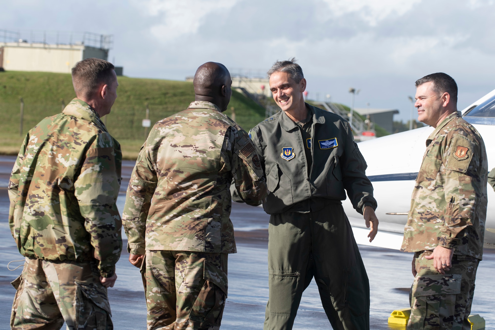 U.S. Air Force Lt. Gen. Steven Basham, center right, U.S. Air Forces in Europe-Air Forces Africa deputy commander, greets Chief Master Sgt. Ralph Oliver, center left, 423rd Air Base Group command chief, during a visit to Royal Air Force Fairford, England, Oct. 20, 2021. Basham visited RAF Fairford to immerse with Airmen from the 9th Expeditionary Bomb Squadron who are temporarily stationed at Fairford for a BTF deployment. A BTF is the global employment of U.S. Strategic bombers, providing strategic military advantage to achieve national and combatant commander objectives. (U.S. Air Force photo by Senior Airman Jennifer Zima)
