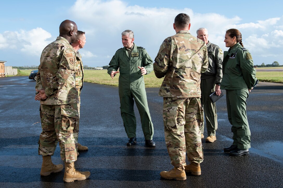 Royal Air Force Air Marshal Andrew Turner, center, RAF Deputy Commander Capability, talks with U.S. Air Force Col. Jon Hannah, second left, 422nd Air Base Group commander, during a visit to Royal Air Force Fairford, England, Oct. 20, 2021. Turner visited Fairford to work together and demonstrate our partnership. Bomber Task Force missions highlight U.S. capabilities and commitment to work closely with our allies and partners to deter any potential adversary from aggressive actions. (U.S. Air Force photo by Senior Airman Jennifer Zima)