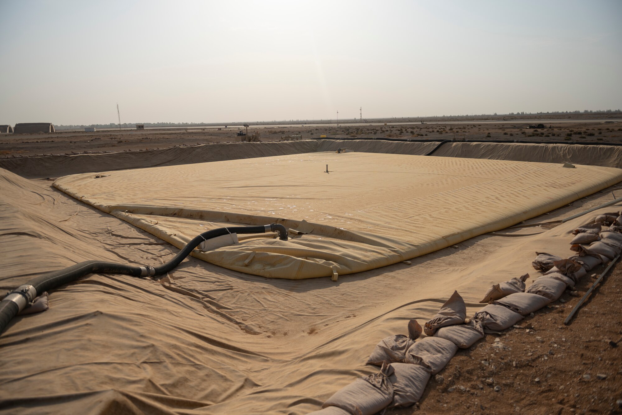 A collapsible fabric tank is pumped full of JP-8 fuel