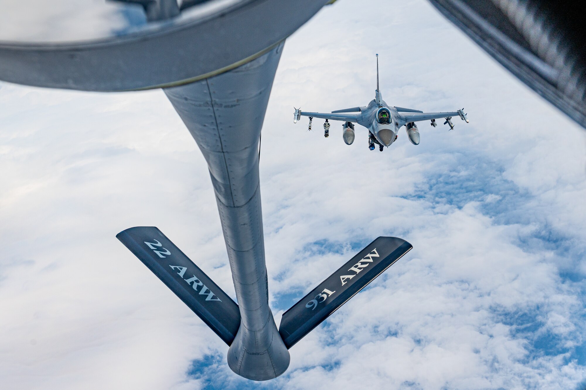 A F-16 approaches a KC-135 for aerial refueling